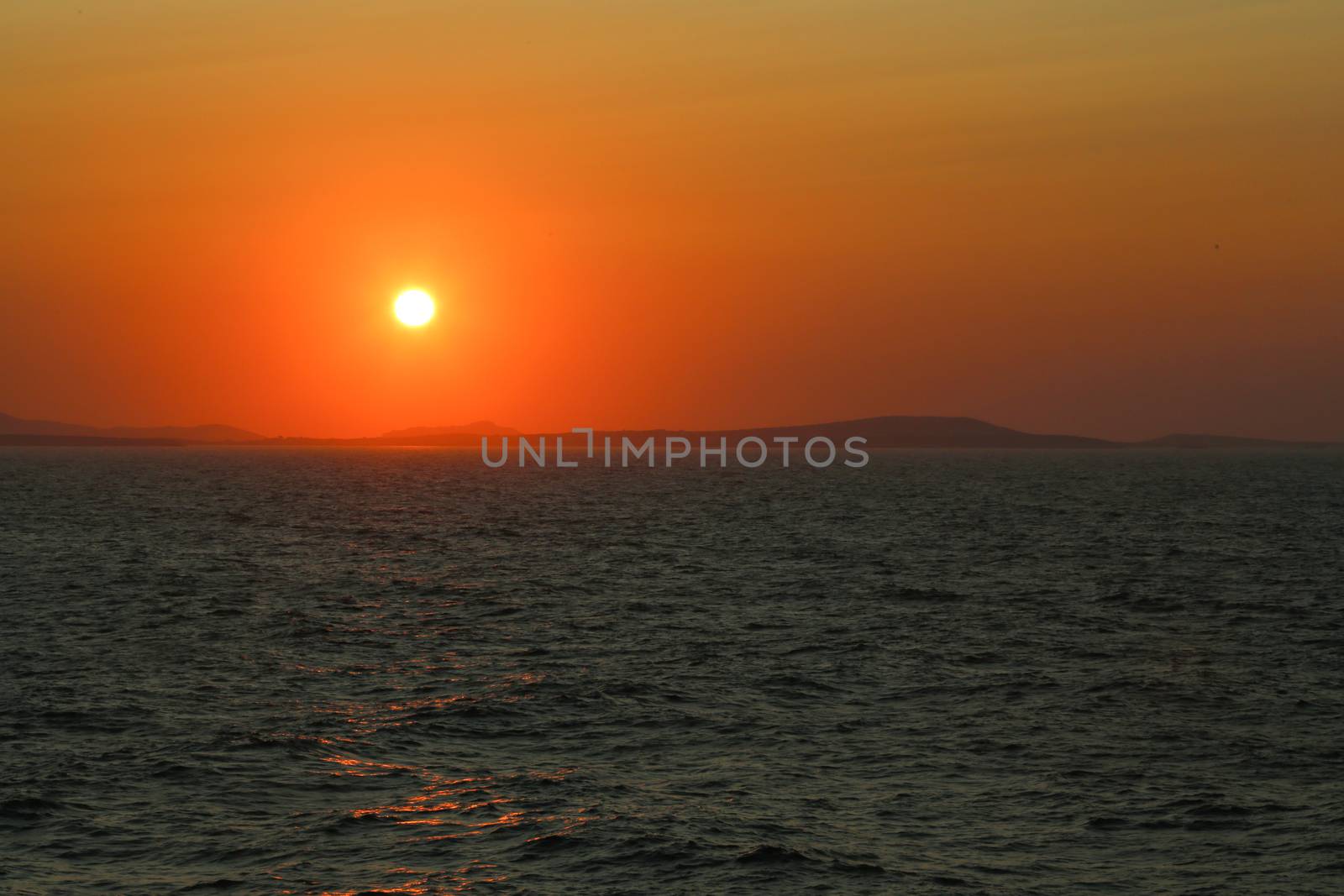 Sunset at the Portara Gate of the Apollo Temple in Naxos island