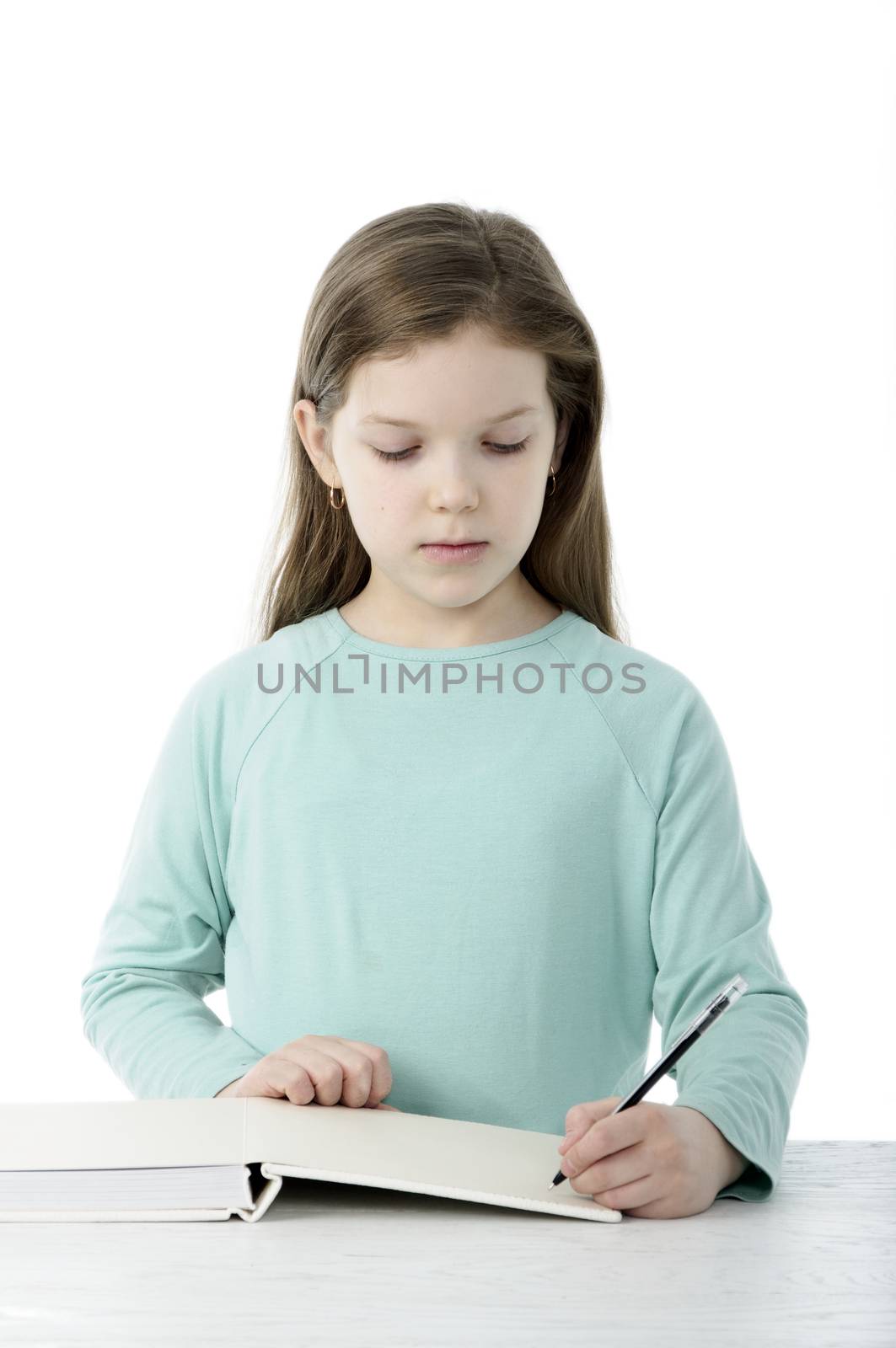 Little girl at the table in school on white by velkol