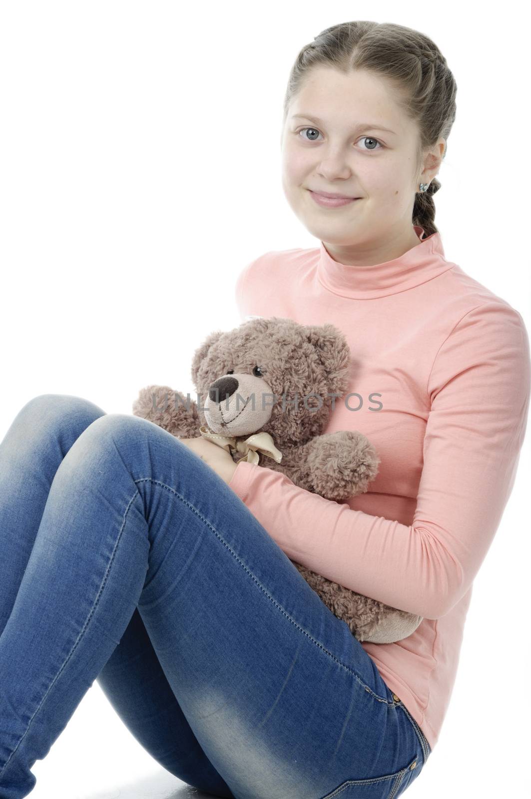 Portrait of pretty little girl holding teddy bear on white by velkol