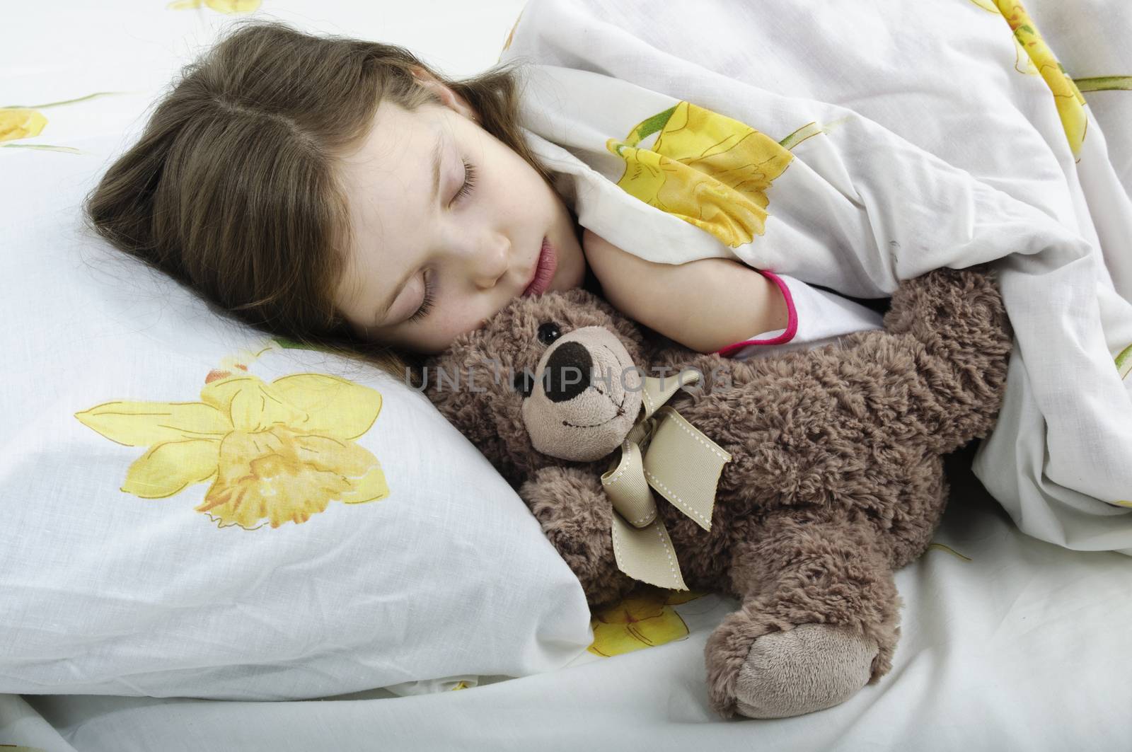 Little girl sleeping in bed with teddy bear by velkol