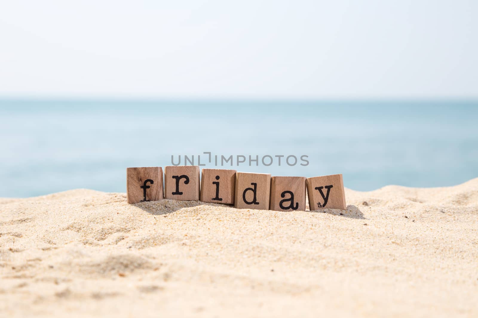 Friday word on sea sand beach by vinnstock