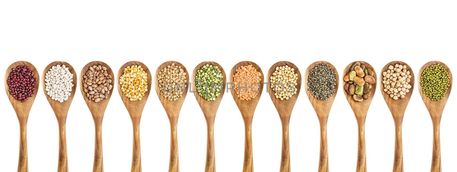 beans, lentils and pea - a collection of food ingredient on isolated wooden spoons