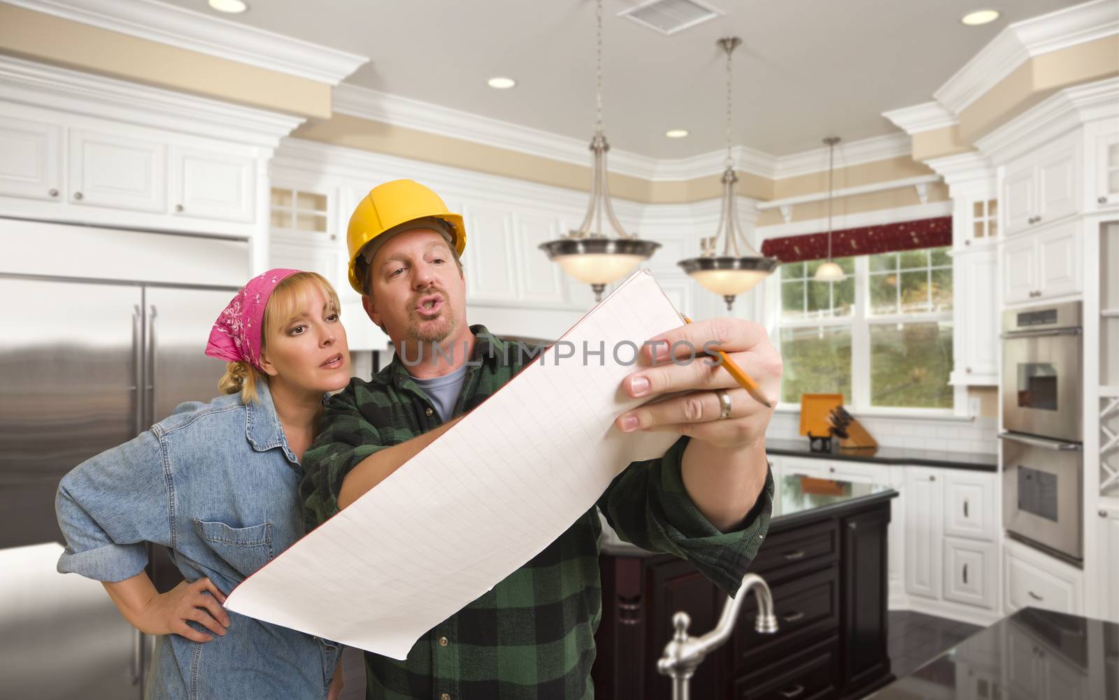 Male Contractor in Hard Hat Discussing Plans with Woman in Custom Kitchen Interior.