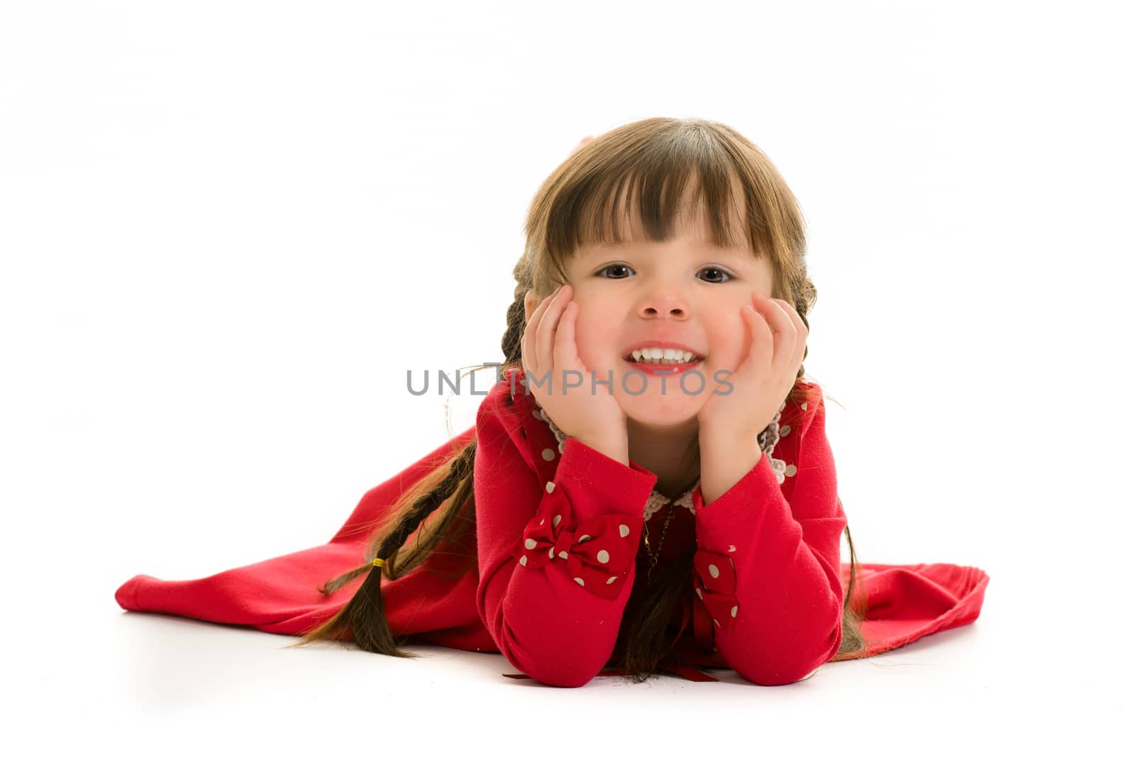 Child lying down with hands on face.