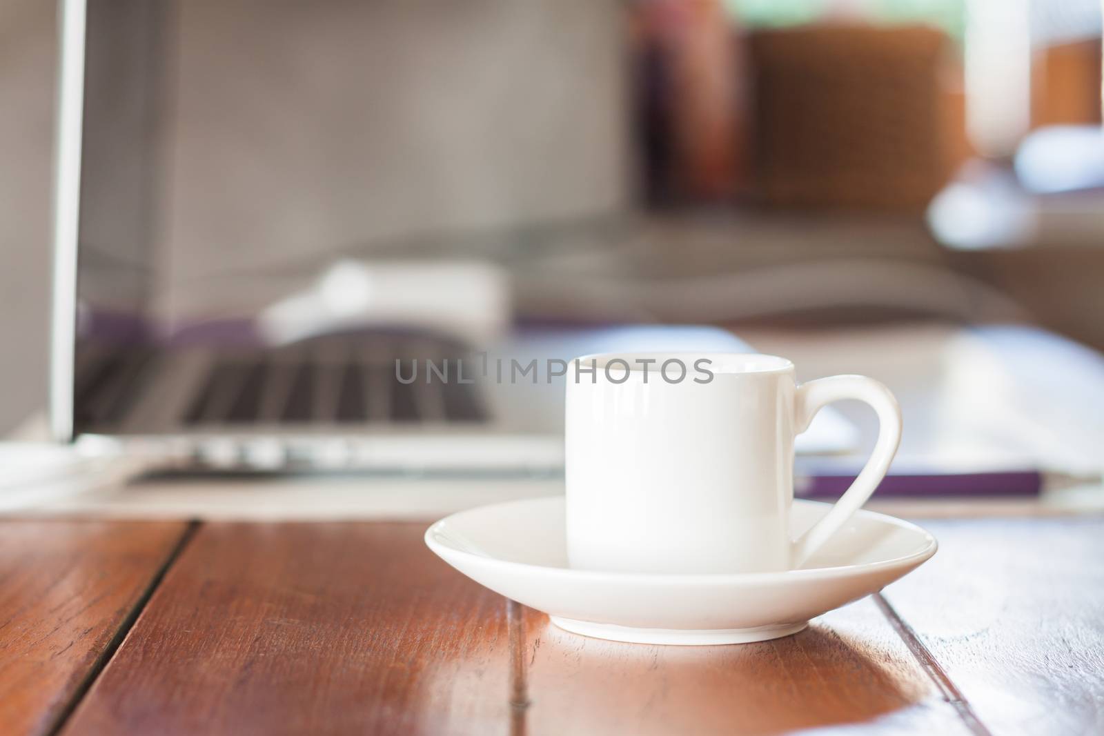 Mini white coffee cup on work station, stock photo