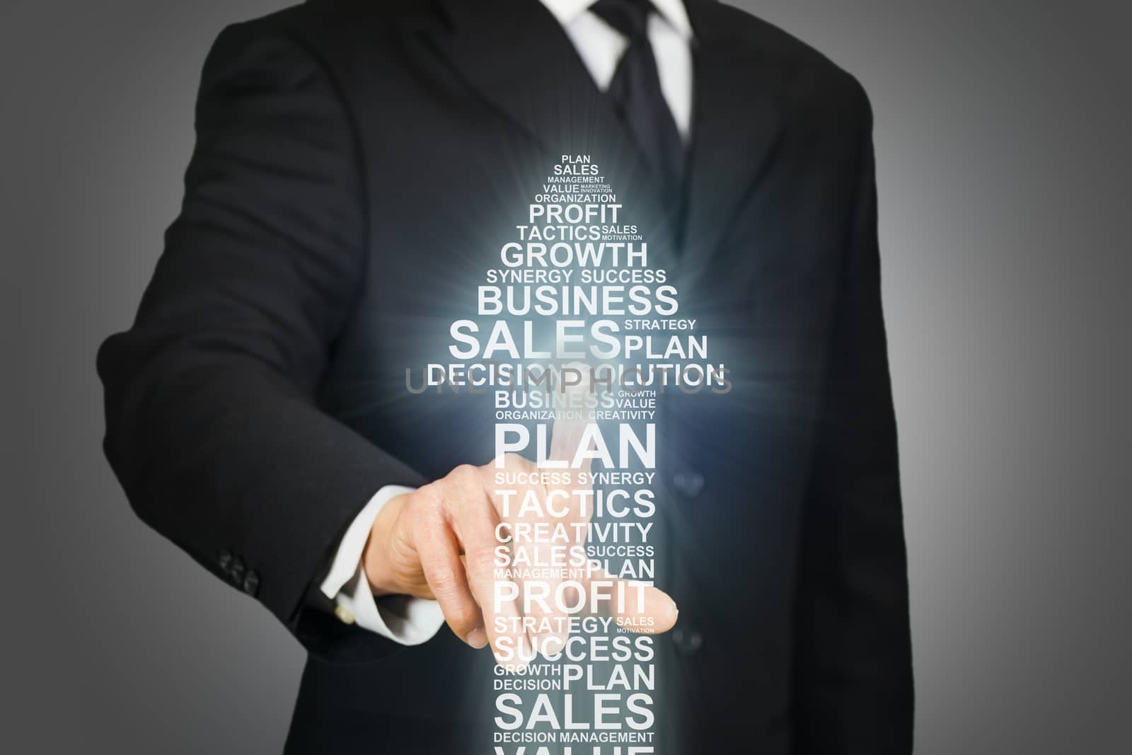 Businessman clicking on an upward arrow formed by business related words