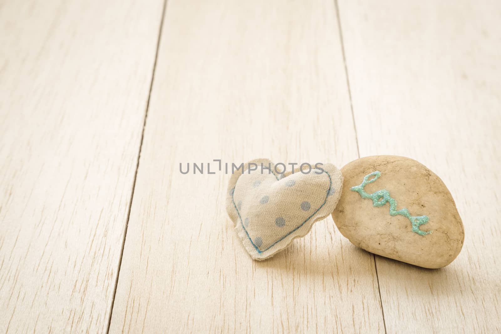 Sweet heart craft and glitter love word on pebble by vinnstock
