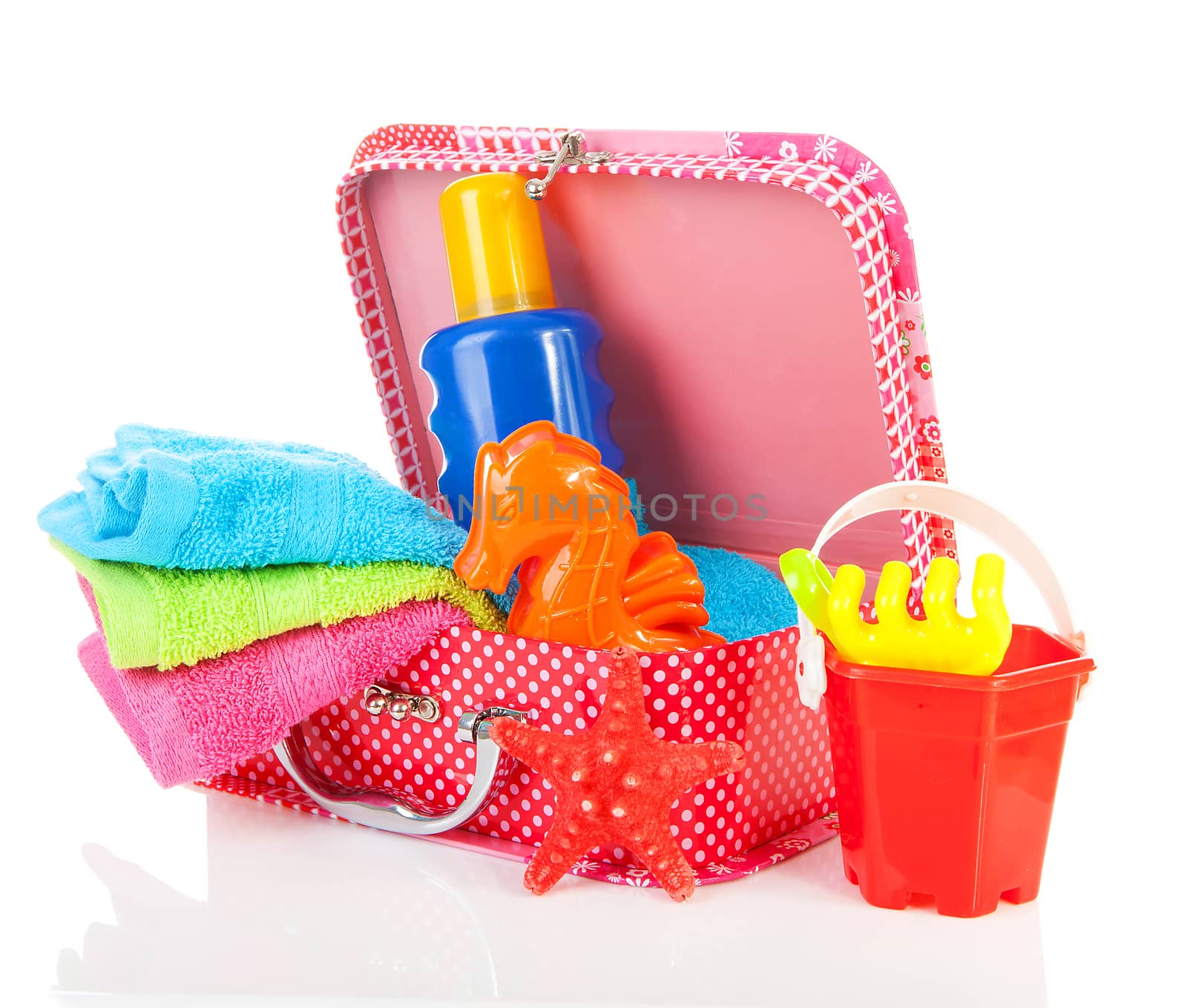 Going to the beach; accessories and suitcase over white background