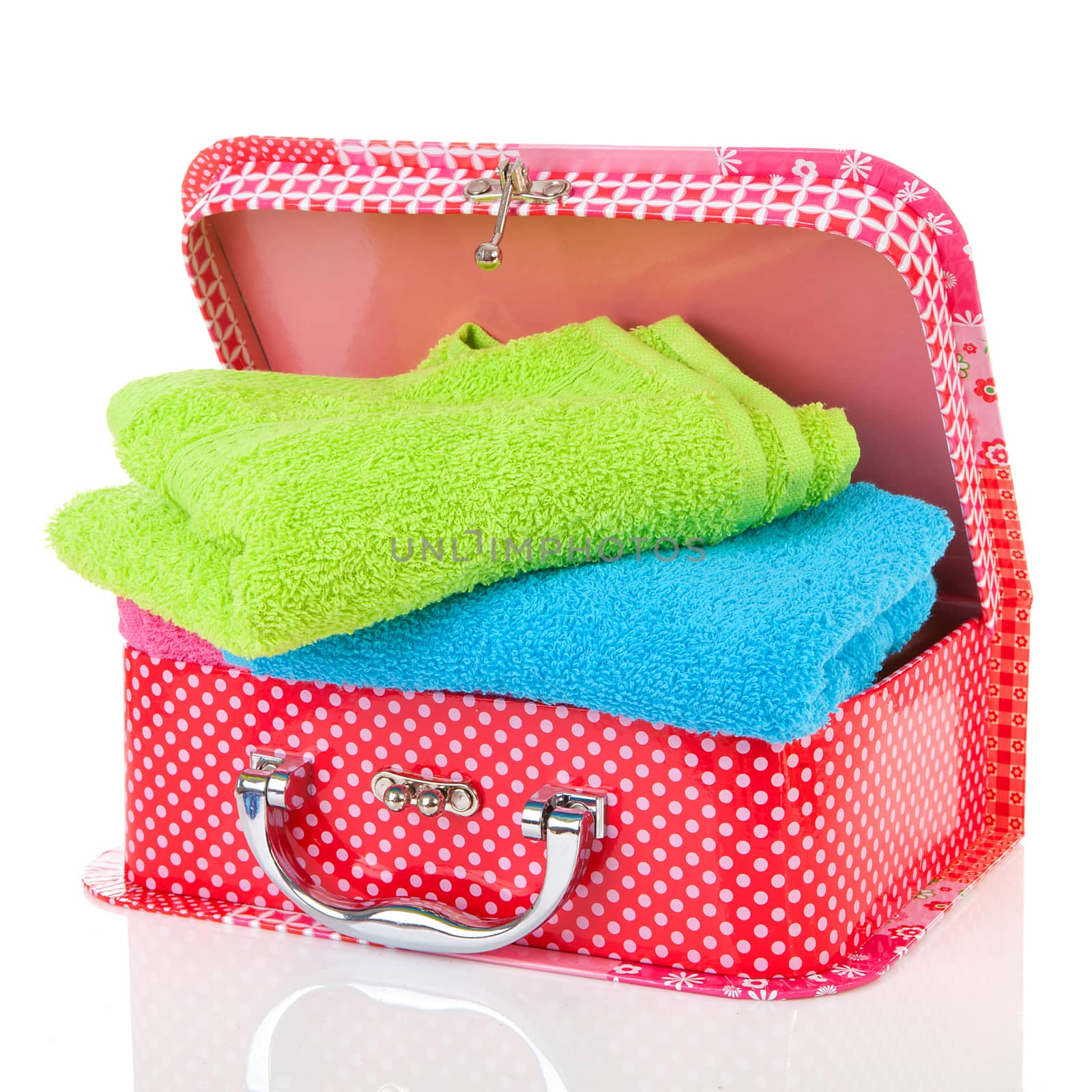 Suitcase and towels over white background