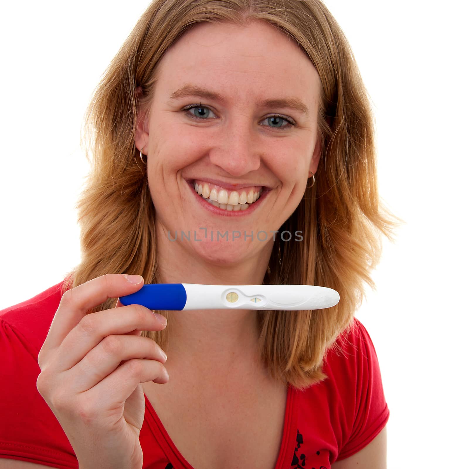 Woman with pregnancy tast is smiling because she is pregnant, over white background