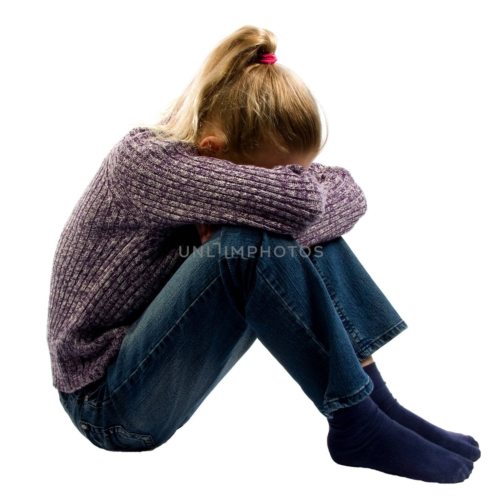 sad girl sitting on ground crying over white background