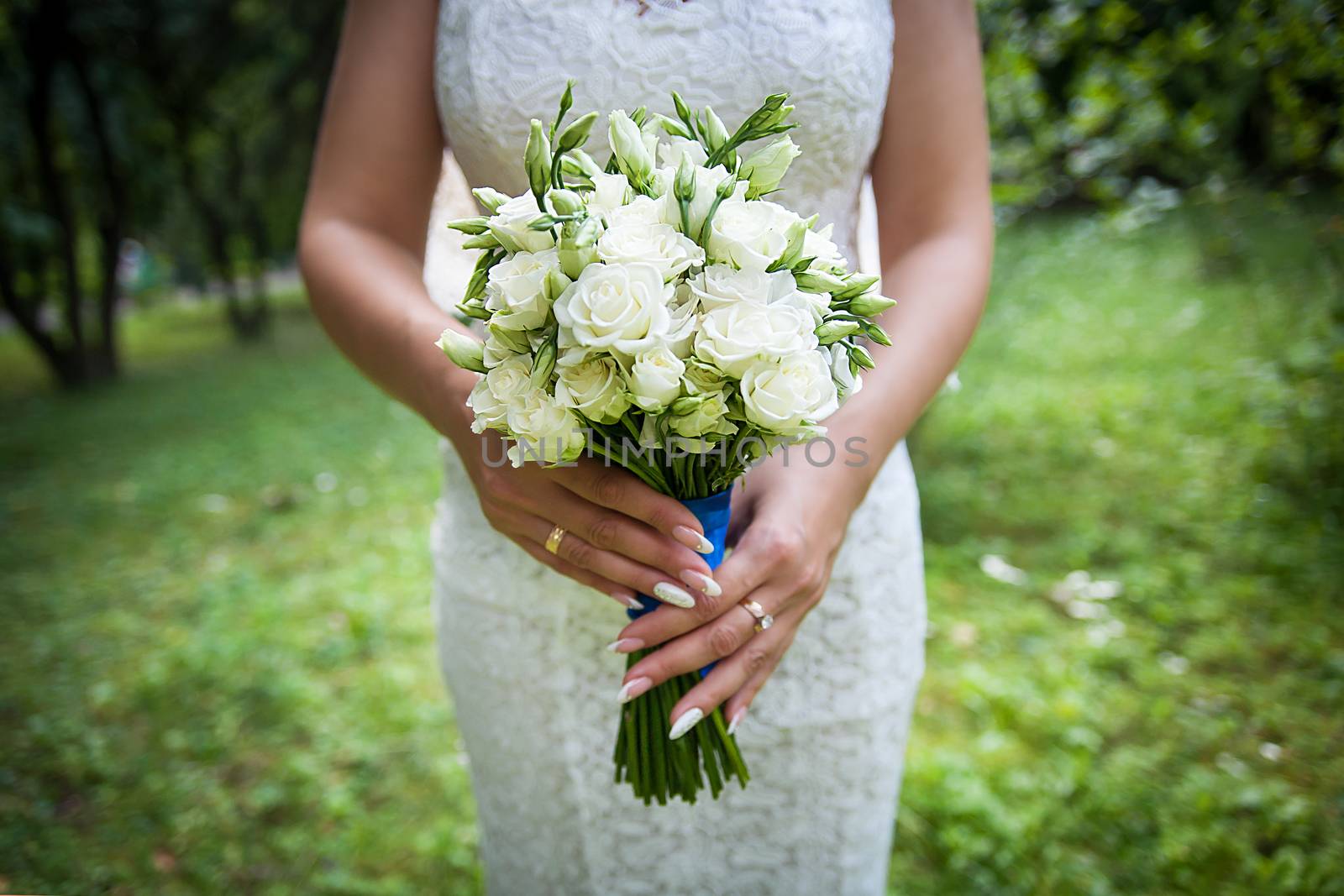 Beautiful wedding bouquet in hands of the bride.