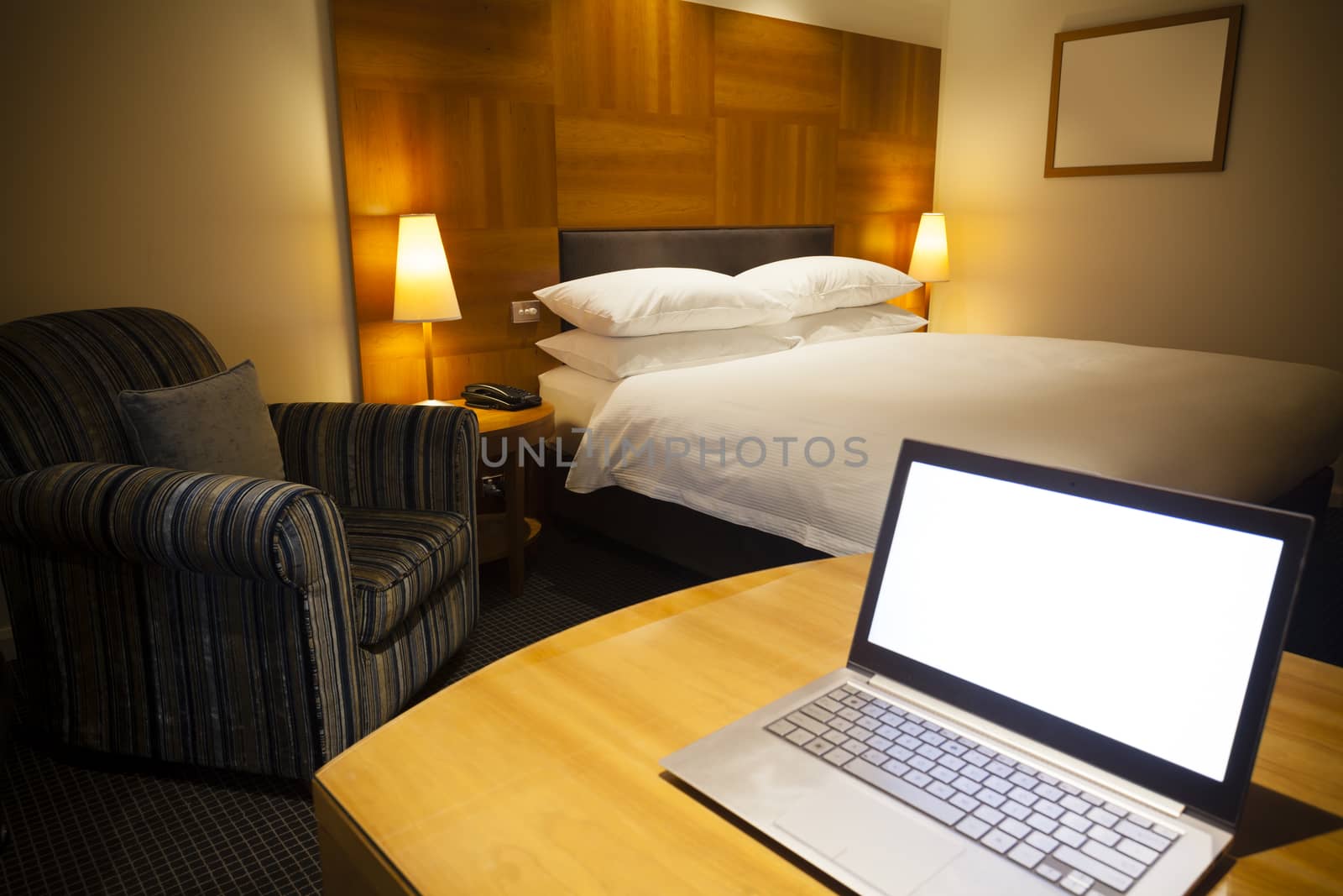 Laptop in a luxurious hotel room by ymgerman