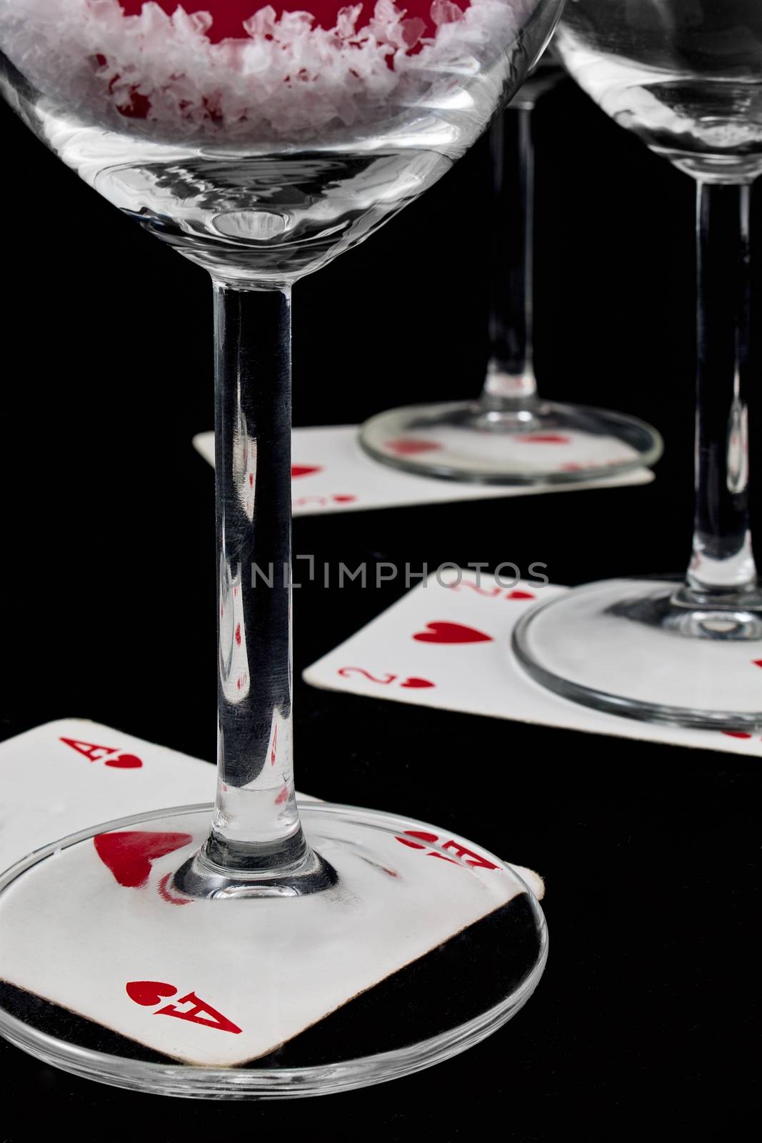 playing card below a glass