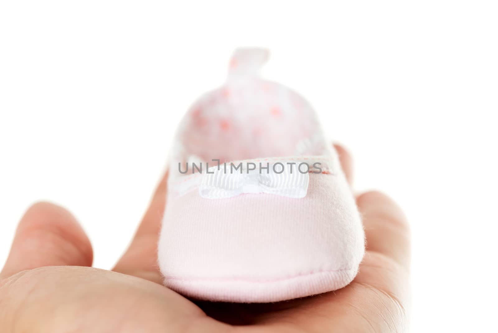 Close up pink baby shoes isolated on white background