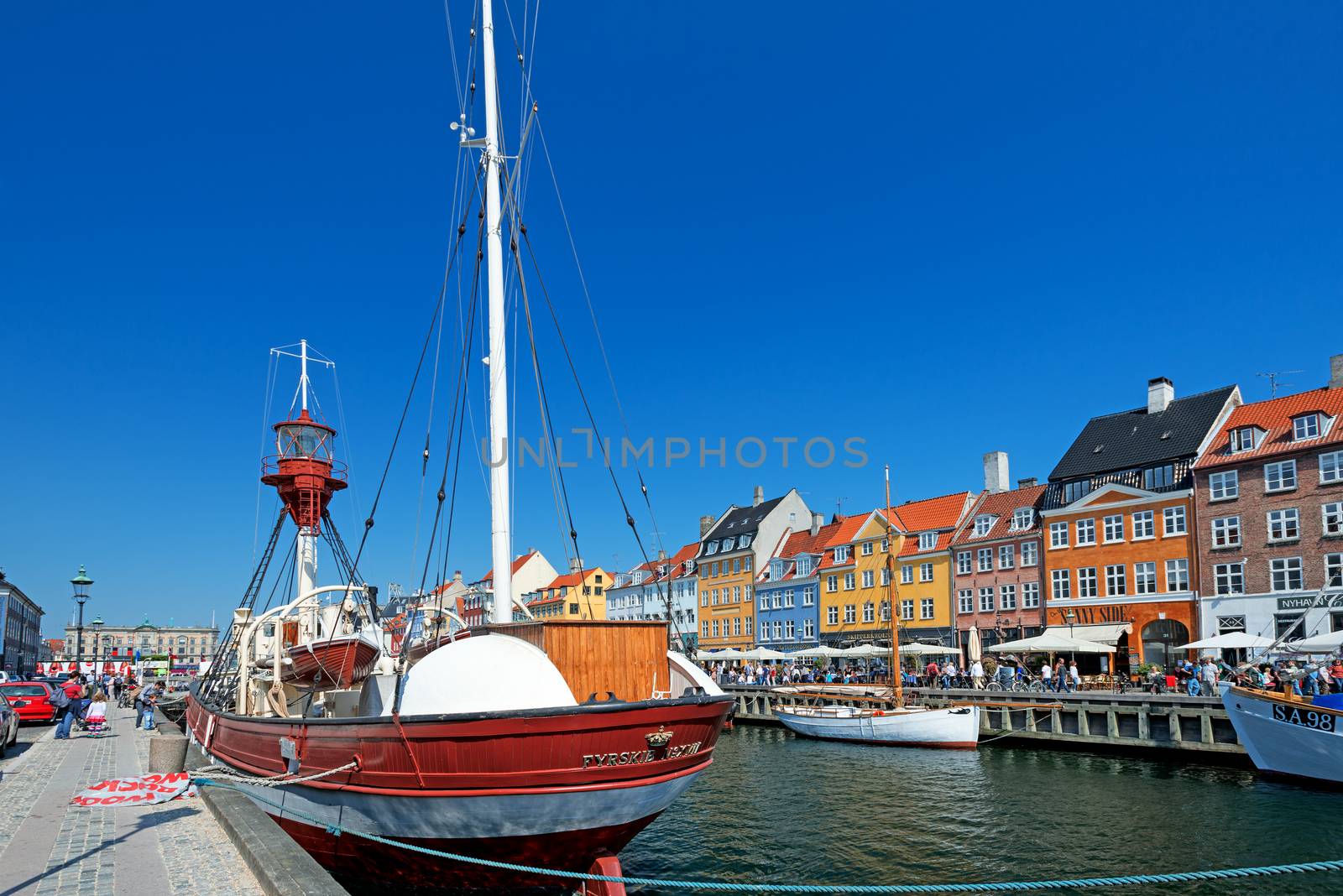 COPENHAGEN, DENMARK - MAY 18: unidentified people in open cafes of the famous Nyhavn promenade on May 18, 2013 in Copenhagen, Denmark. Nyhavn is one of the most famous landmark of Copenhagen.