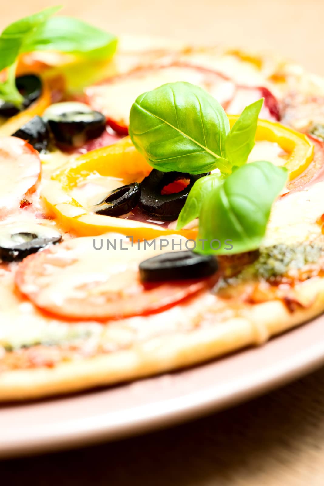 Italian pizza with olives, cheese, pepper and herbs