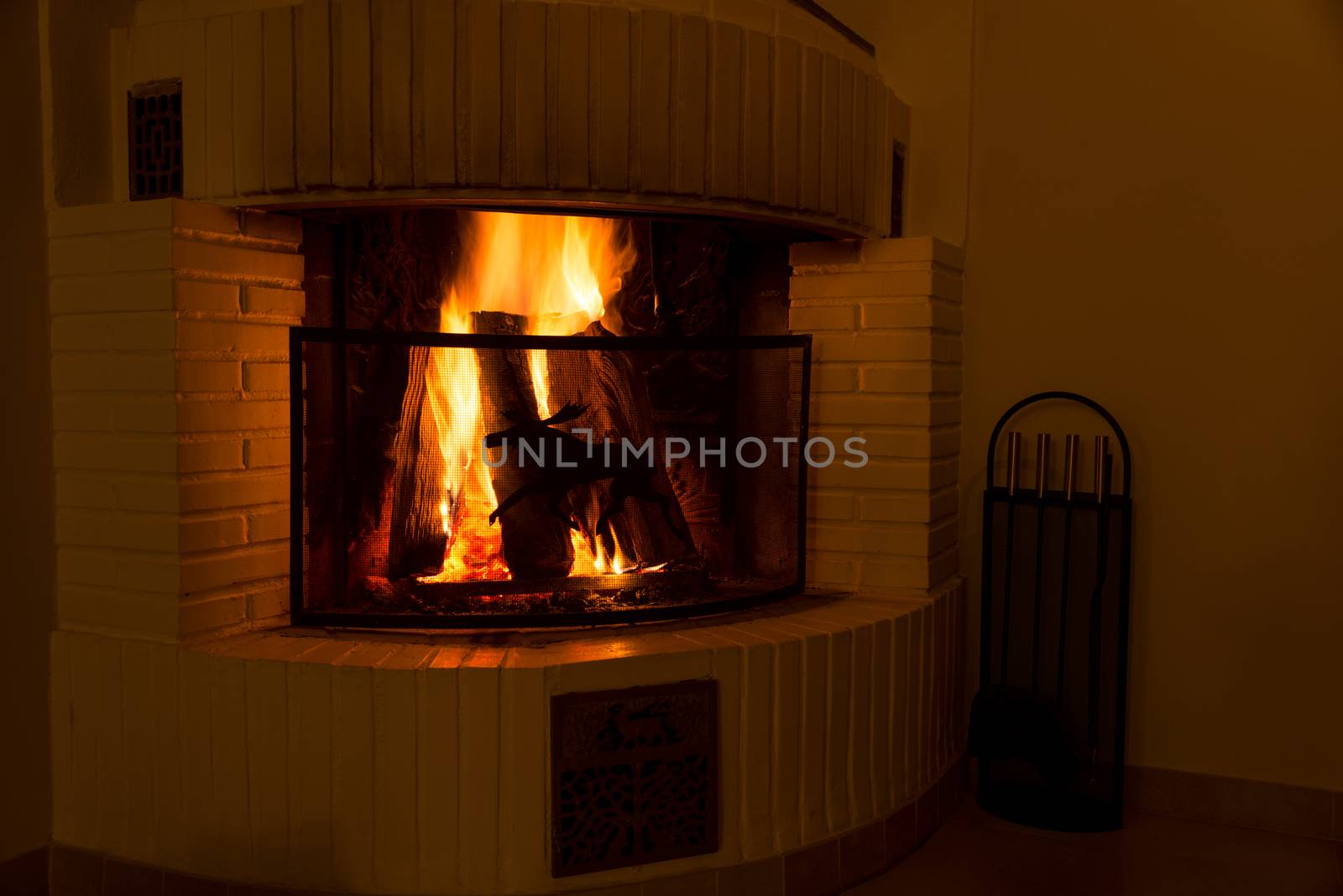 Vintage fireplace with burning logs. Renewable energy concept.