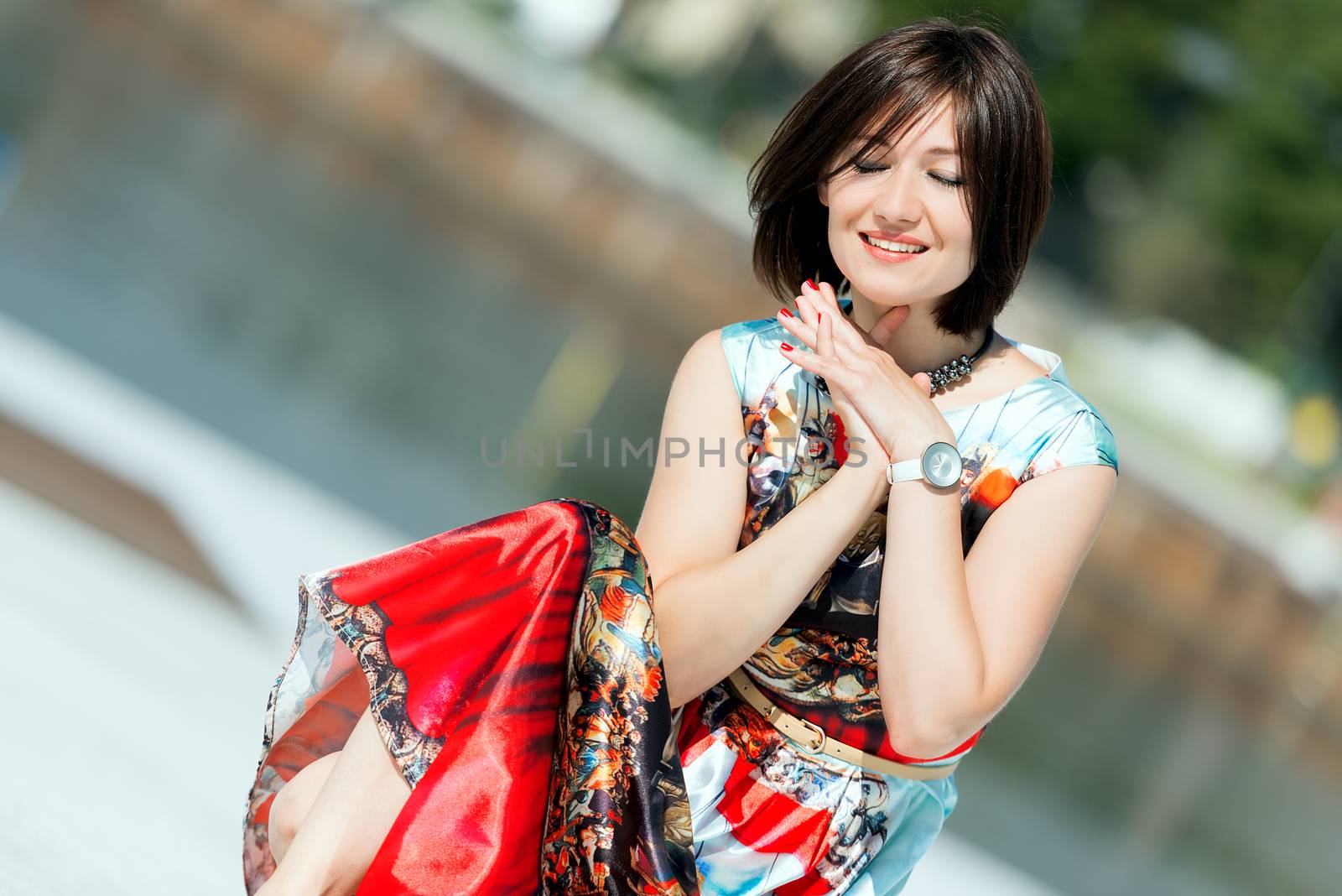 Model in dress posing on exterior set happy by Nanisimova