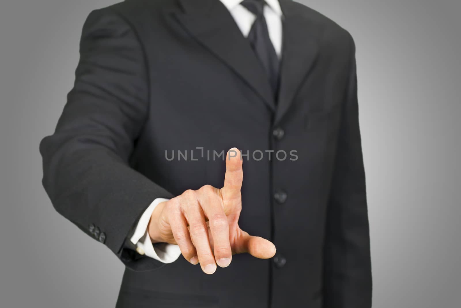 Businessman clicking on touch screen by ymgerman