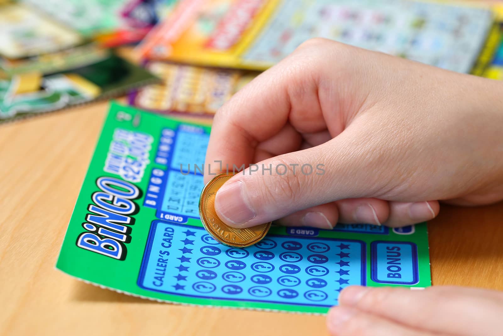 Close up woman scratching lottery tickets. by payphoto