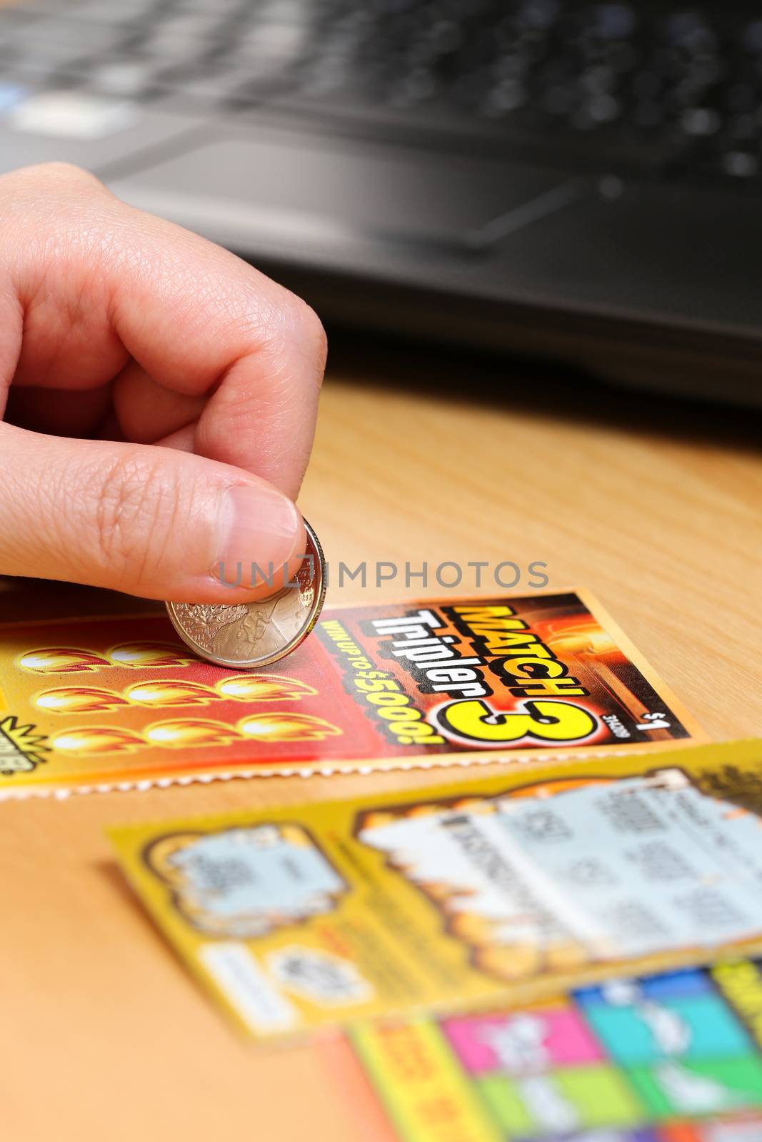 Coquitlam BC Canada - June 15, 2014 : Woman scratching lottery tickets. The British Columbia Lottery Corporation has provided government sanctioned lottery games in British Columbia since 1985. 