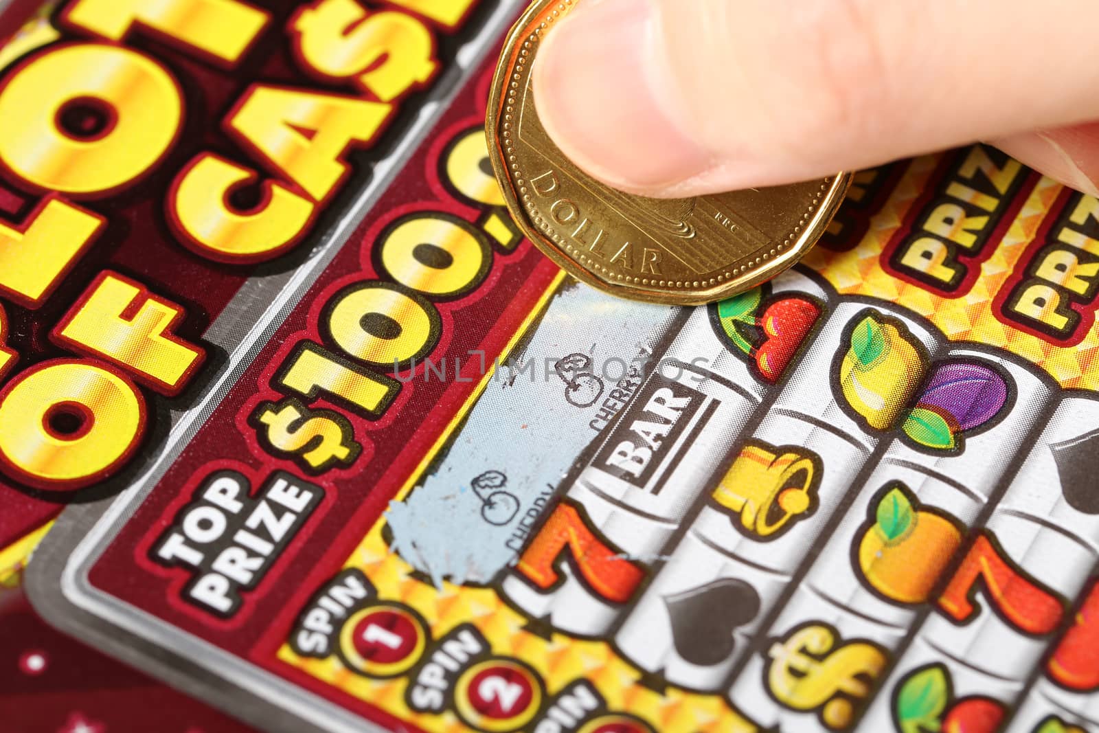 Close up woman scratching lottery tickets. by payphoto