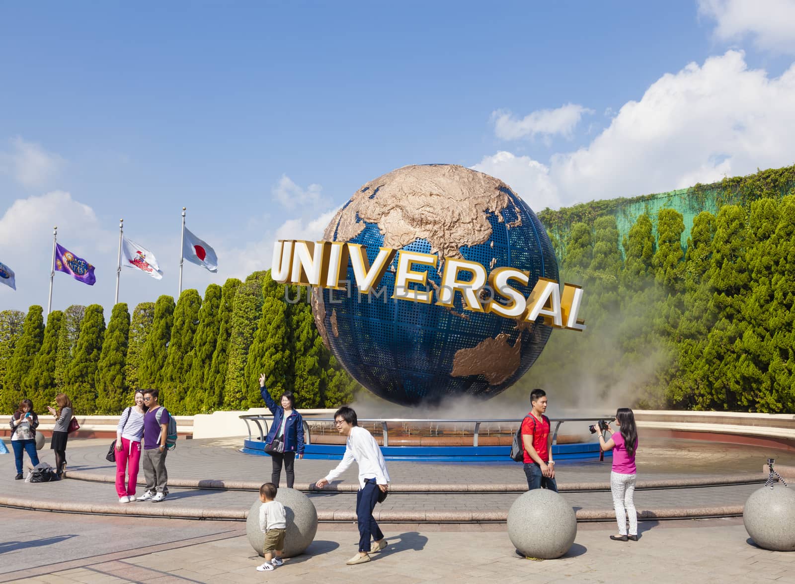 Osaka, Japan - Oct 27: View of tourists and Universal Globe outside the Universal Studios Theme Park in Osaka, Japan on Oct 27, 2014.  The theme park has many attractions based on the film industry.