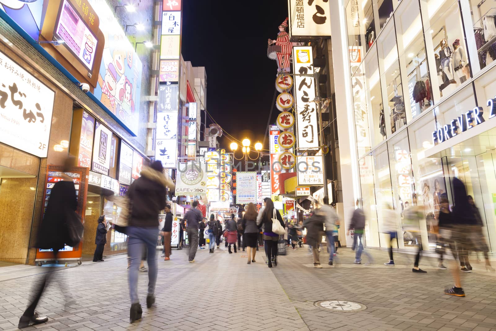 Osaka, Japan - Oct 28: Tourists visiting Dotonbori in Osaka, Japan at night on Oct 28, 2014.  Dotonbori is one of the principal tourist destinations in Osaka, Japan.