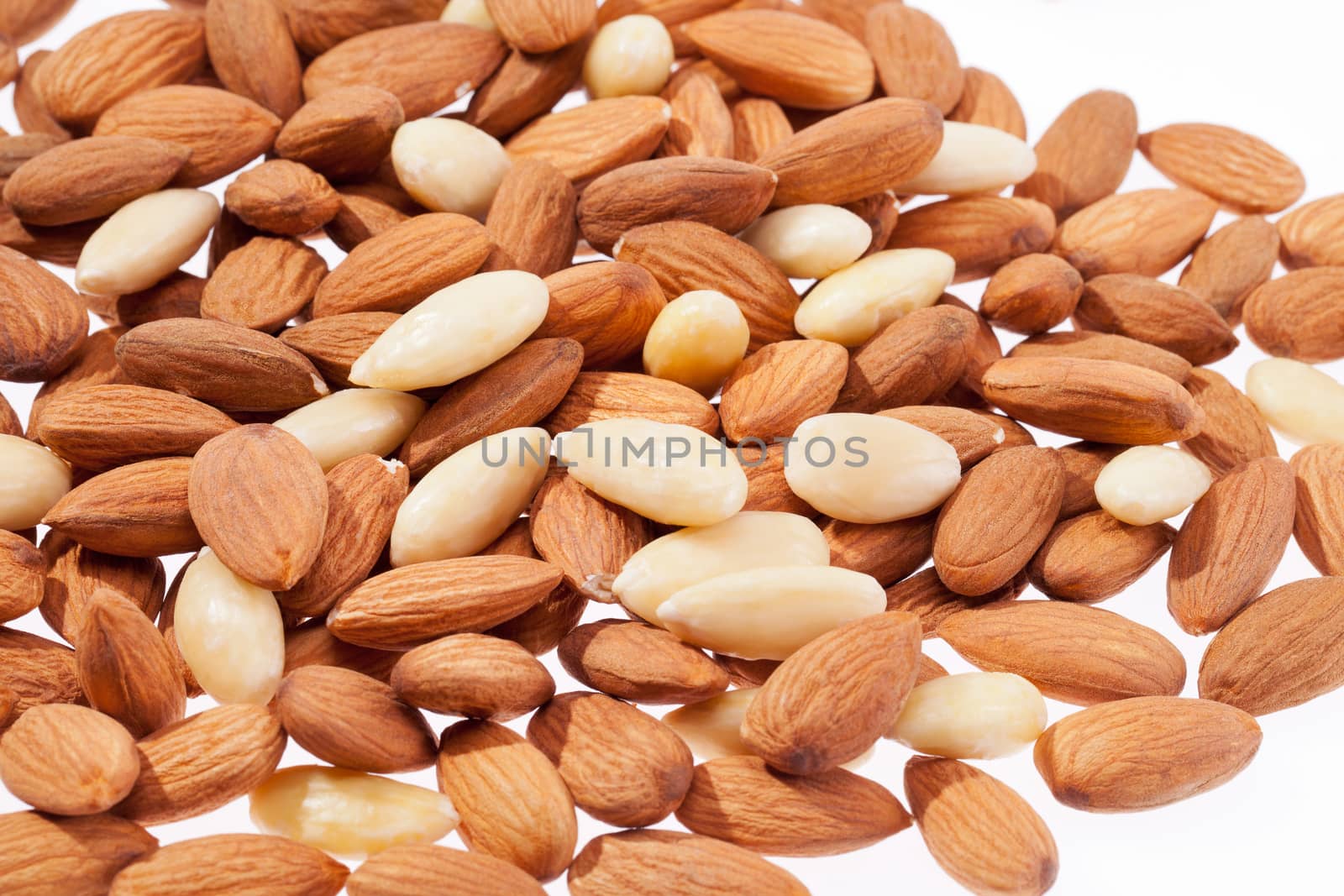 background  of group of brown and white almond isolated on white background closeup