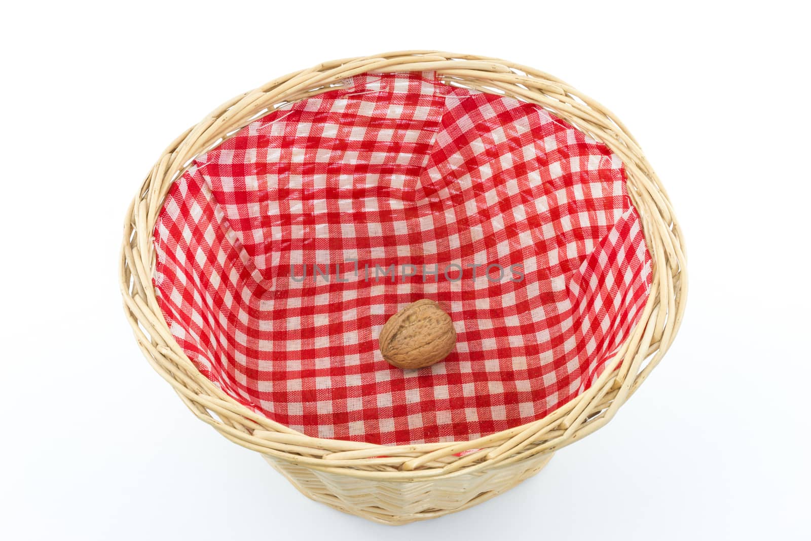 Almost empty small basket with one walnut