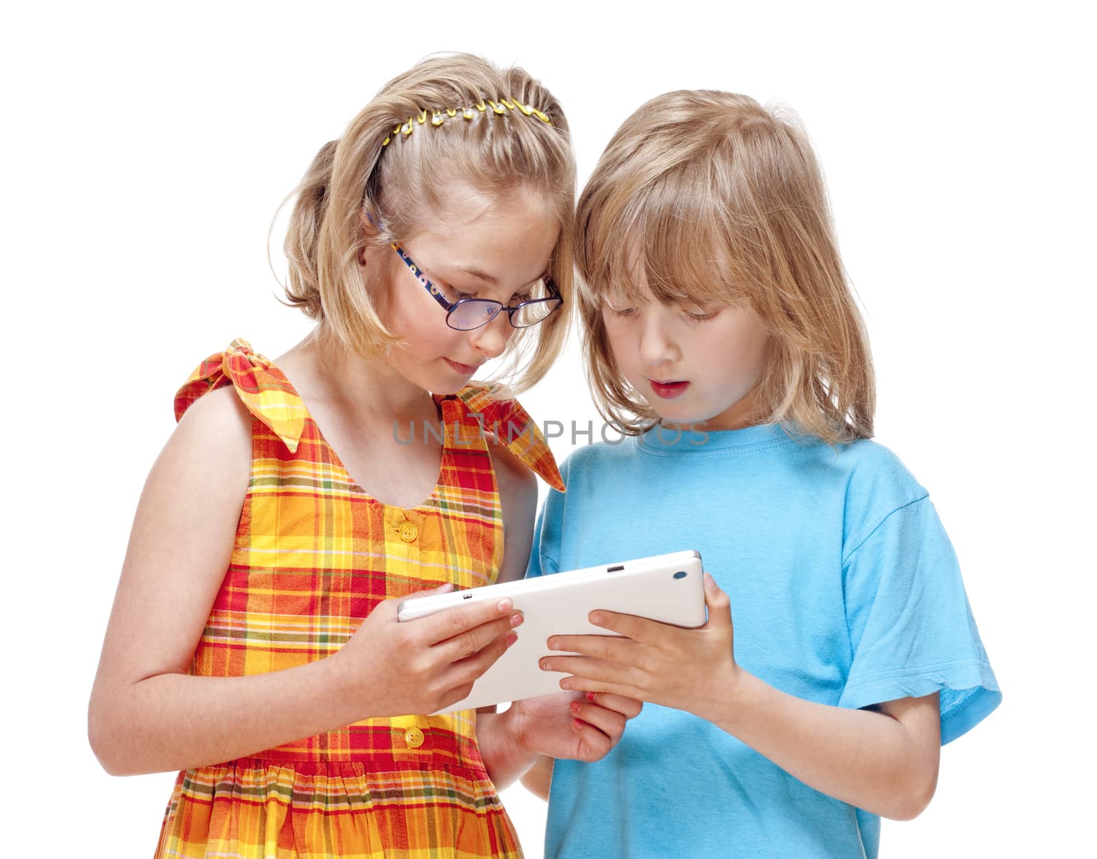 Two Children Having Fun with Digital Tablet by courtyardpix