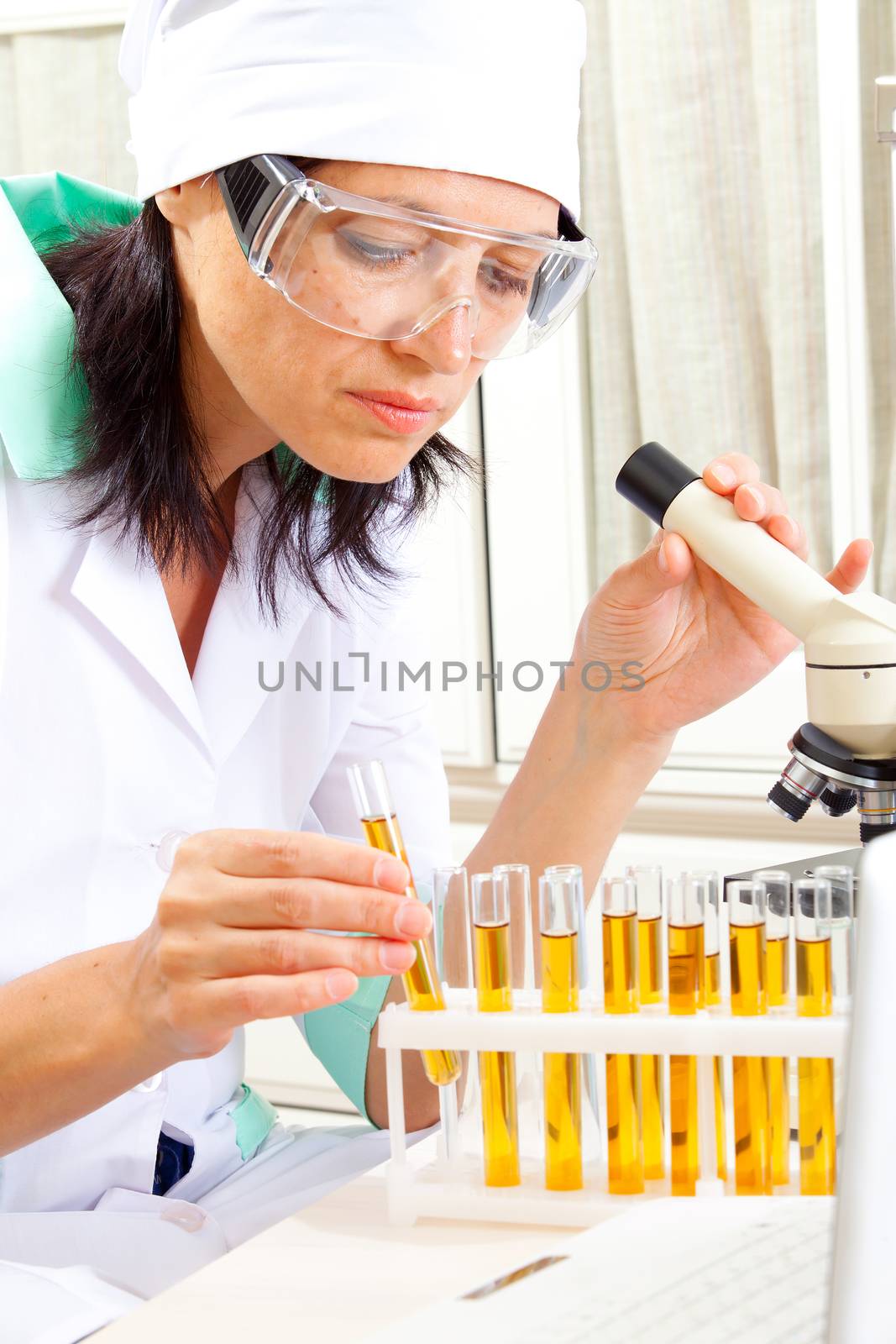 female scientist microscoping in the life science research laboratory (genetics, biochemistry, forensics, microbiology) 