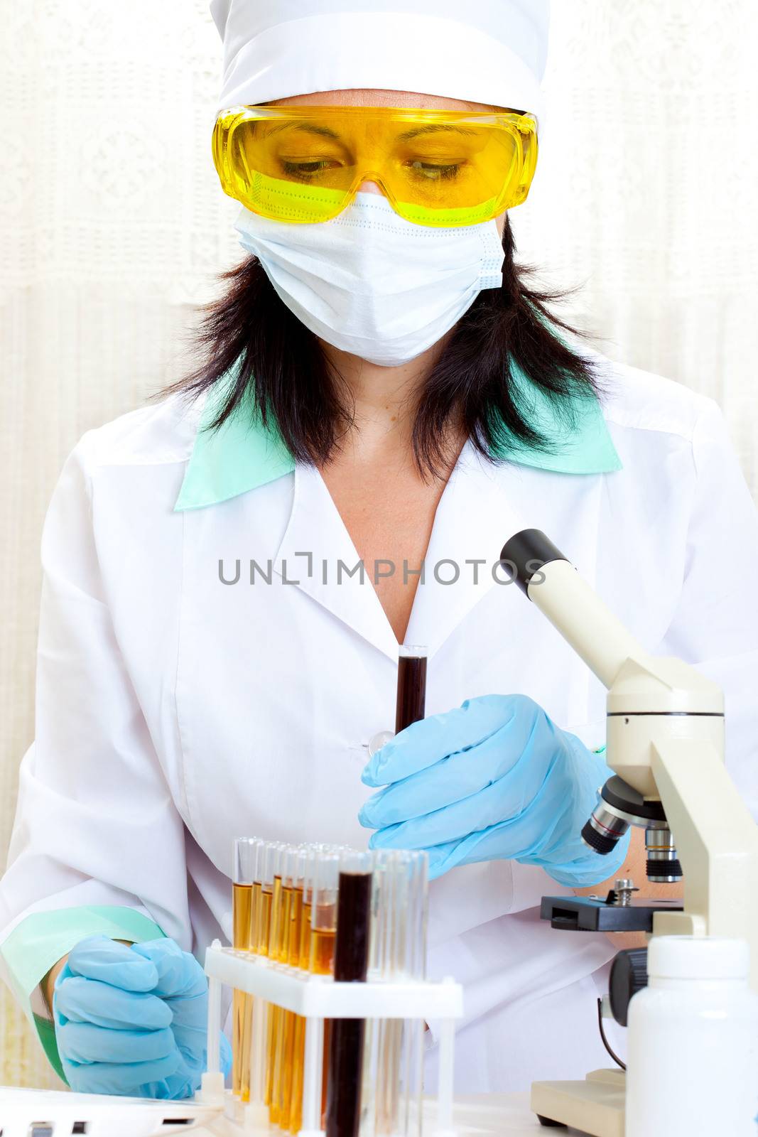 female scientist microscoping in the life science research laboratory (genetics, biochemistry, forensics, microbiology) 