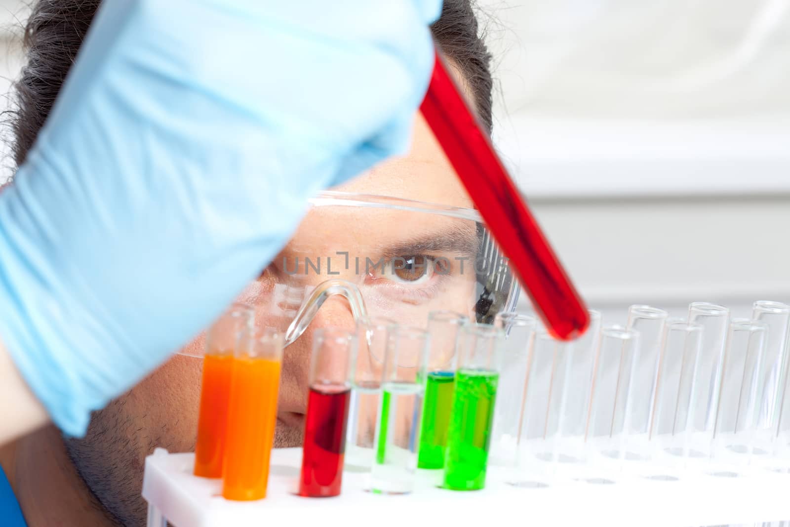 researcher analyzes the contents of the tube with liquid