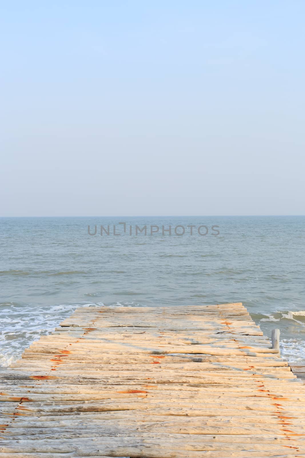 wooden pier to the sea and sky