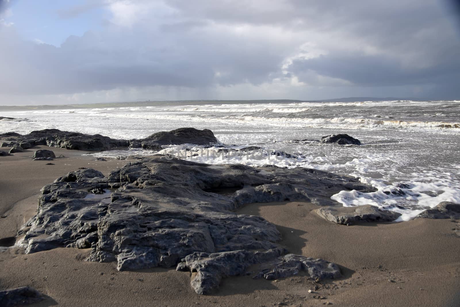 the black rocks on Ballybunion beach in county Kerry Ireland after a storm