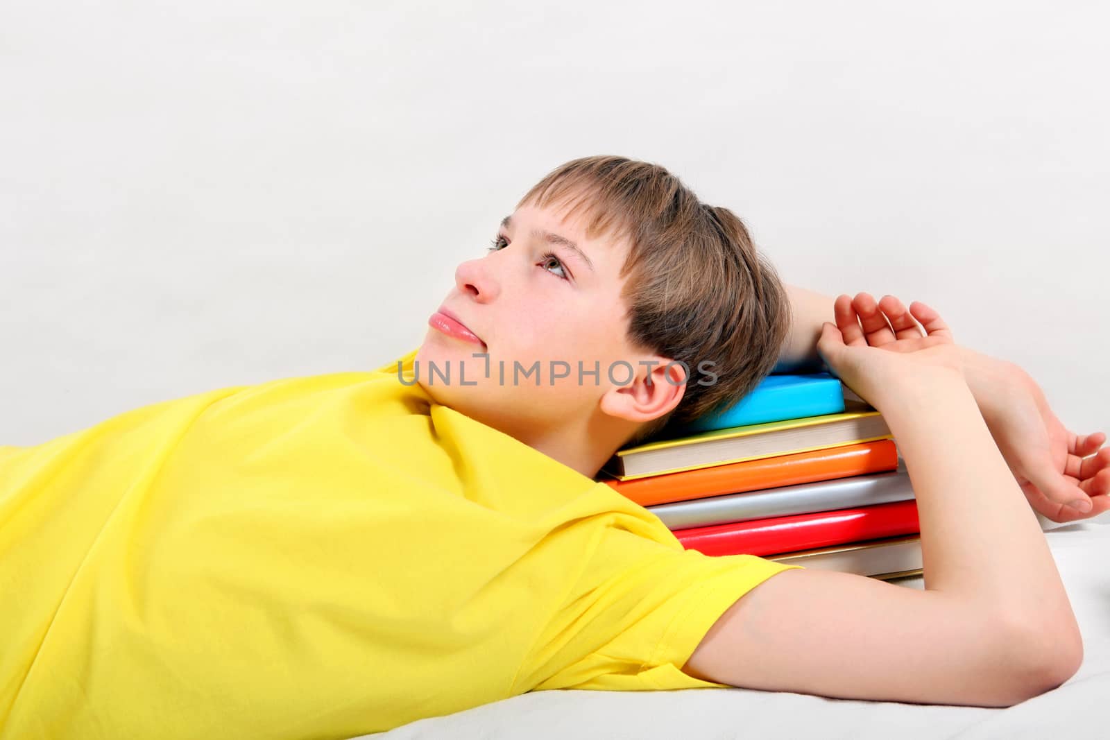 Tired Teenager with a Books by sabphoto