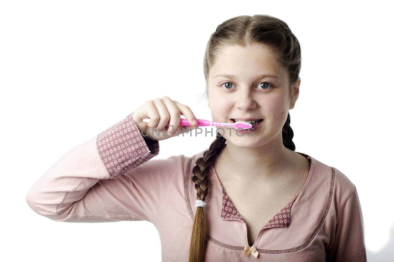 Cute girl brushing teeth on white by velkol