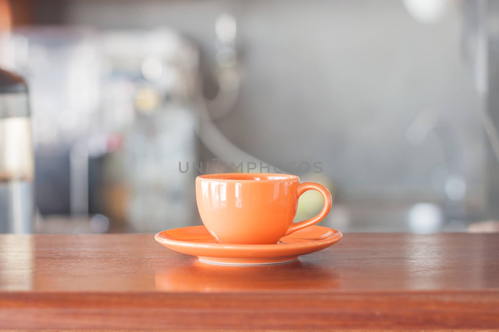 Mini orange coffee cup in coffee shop, stock photo