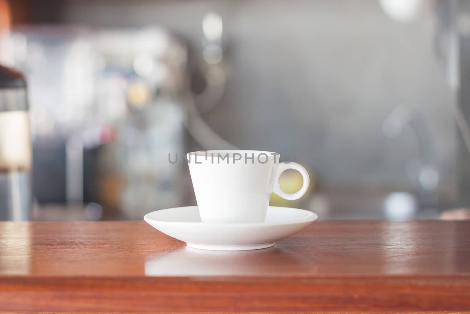 Mini white coffee cup in coffee shop, stock photo