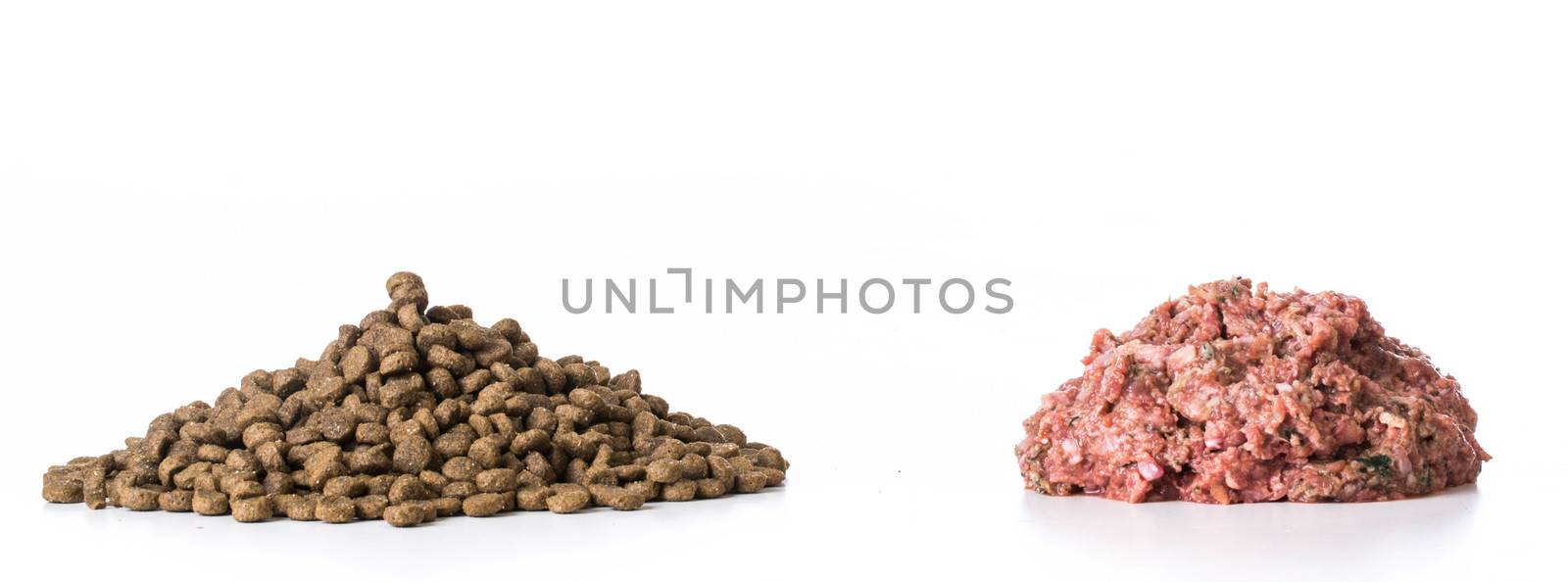 kibble and raw pile of food isolated on white background
