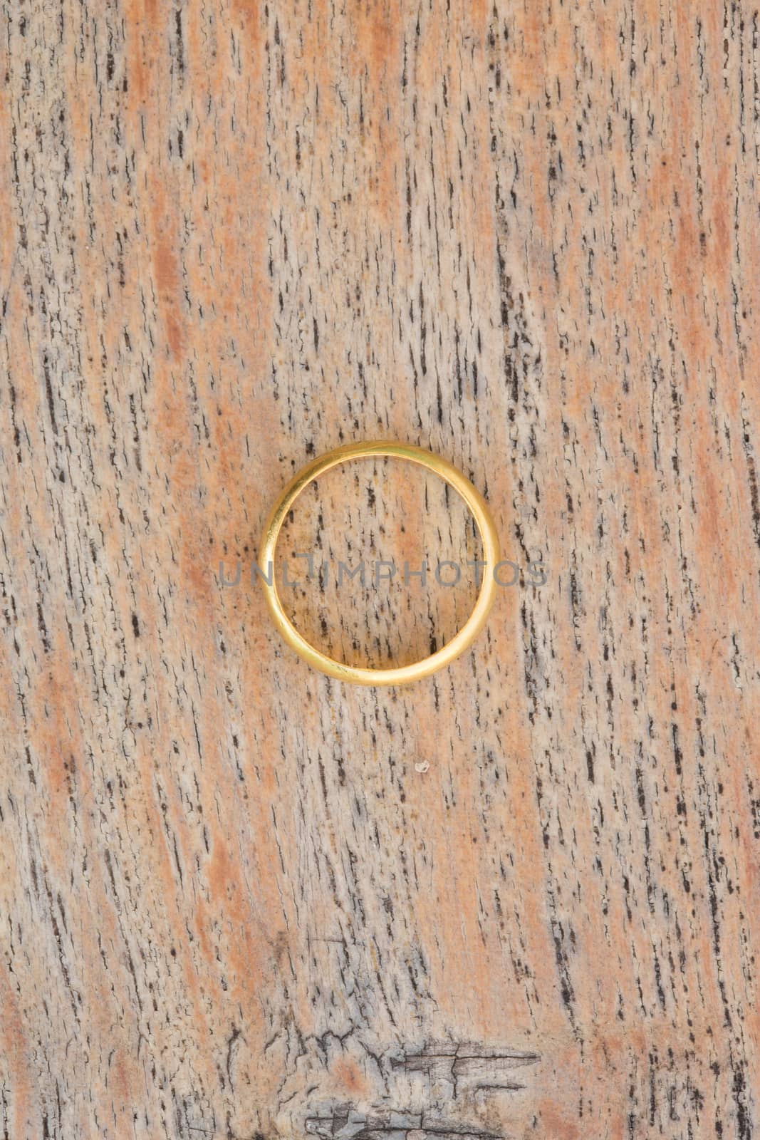 gold rings on wood background