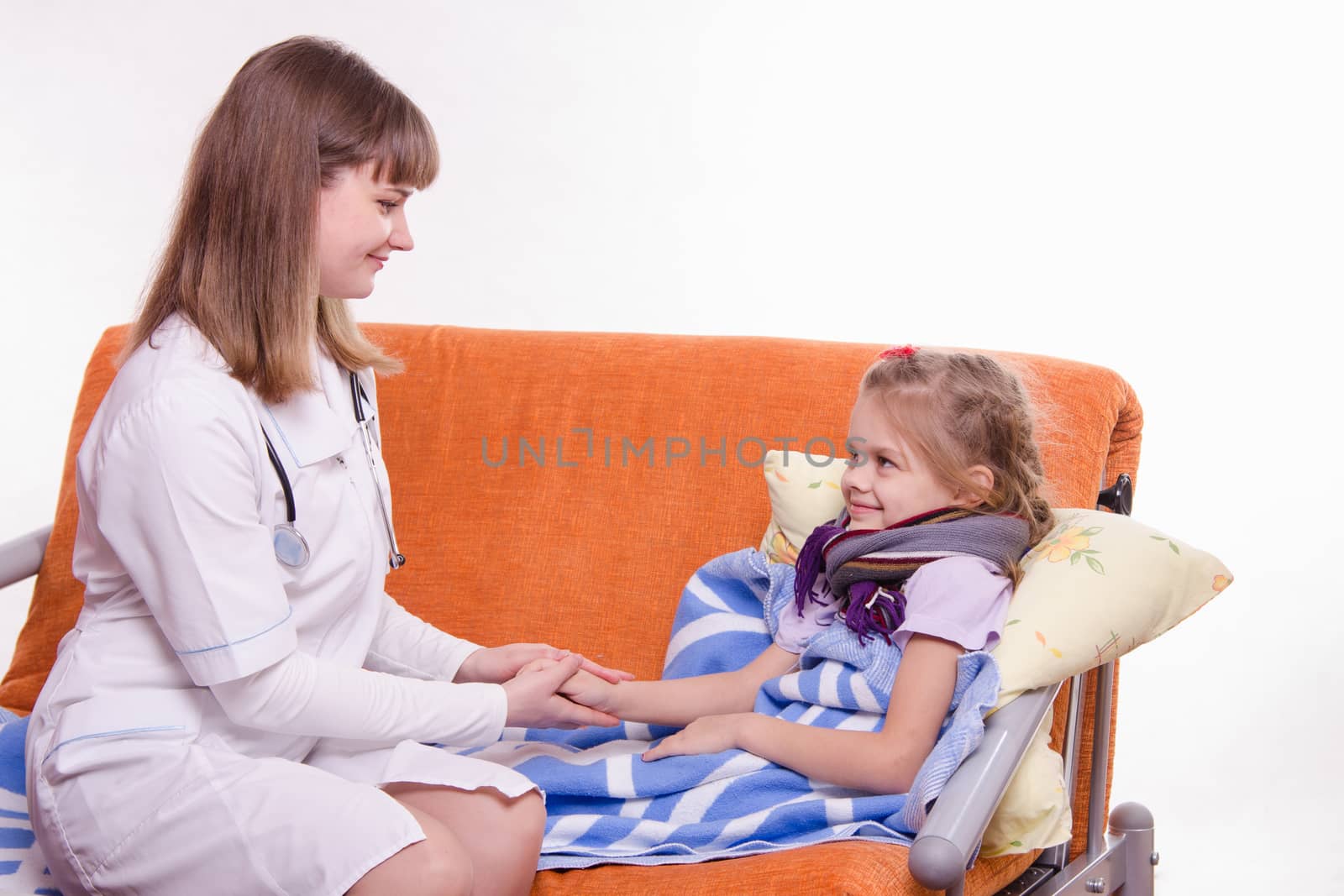 Doctor pediatrician examines a sick child at home