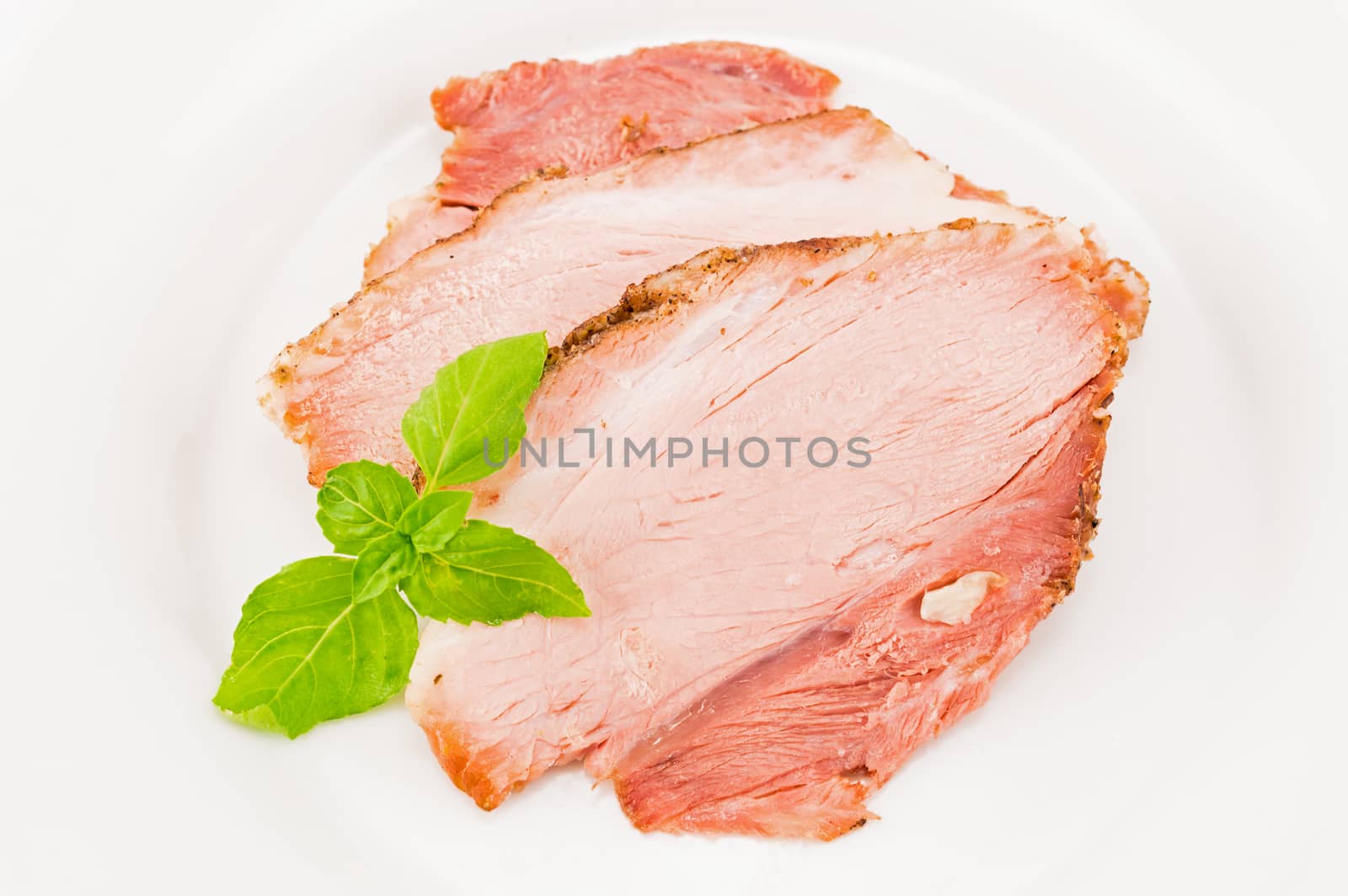 The baked pork and green basil leaves