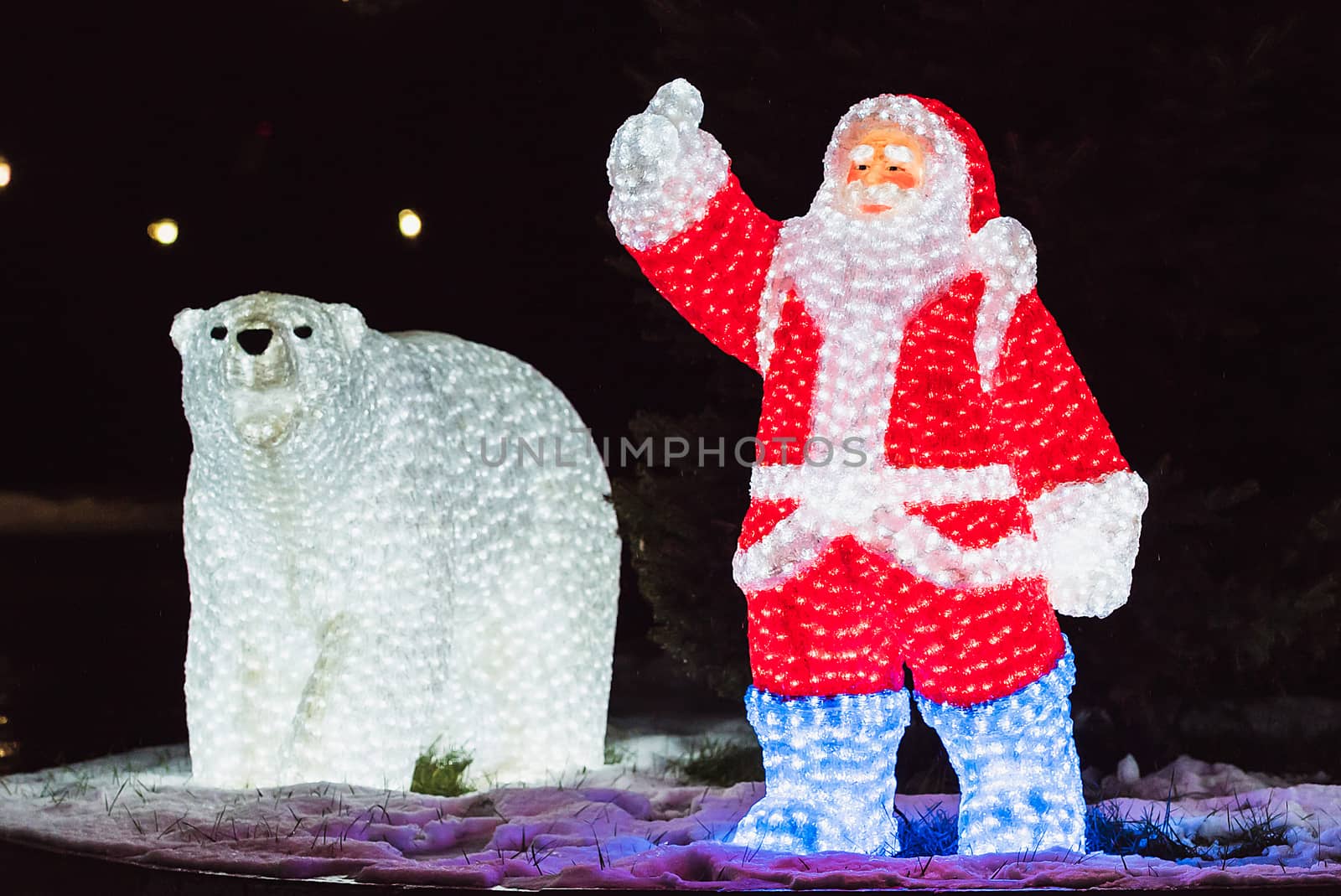 Glowing figures of Santa Claus and the bear