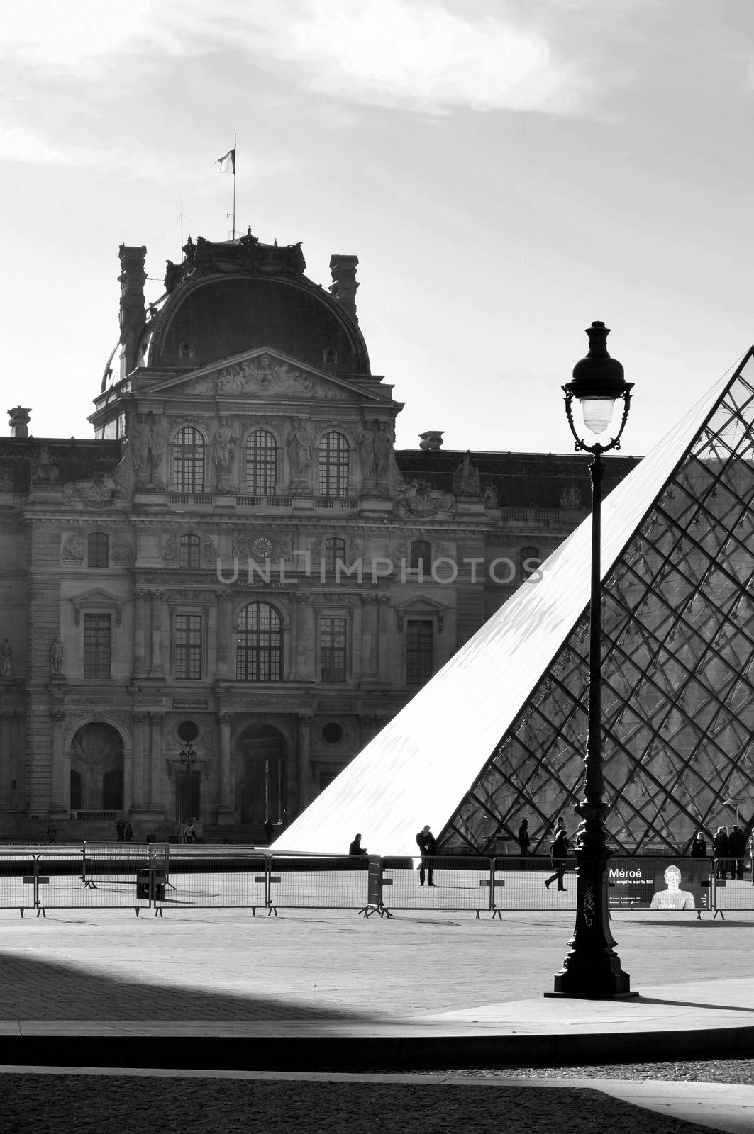 PARIS, FRANCE - CIRCA APRIL 2010: The Louvre Museum and the Pyramid which is the entrance for the museum. Black and white photography.