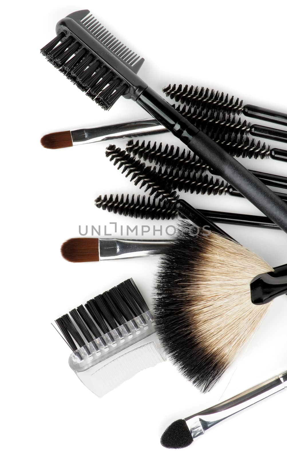 Heap of Various Make-up Brushes and Applicators closeup on white background. Top View