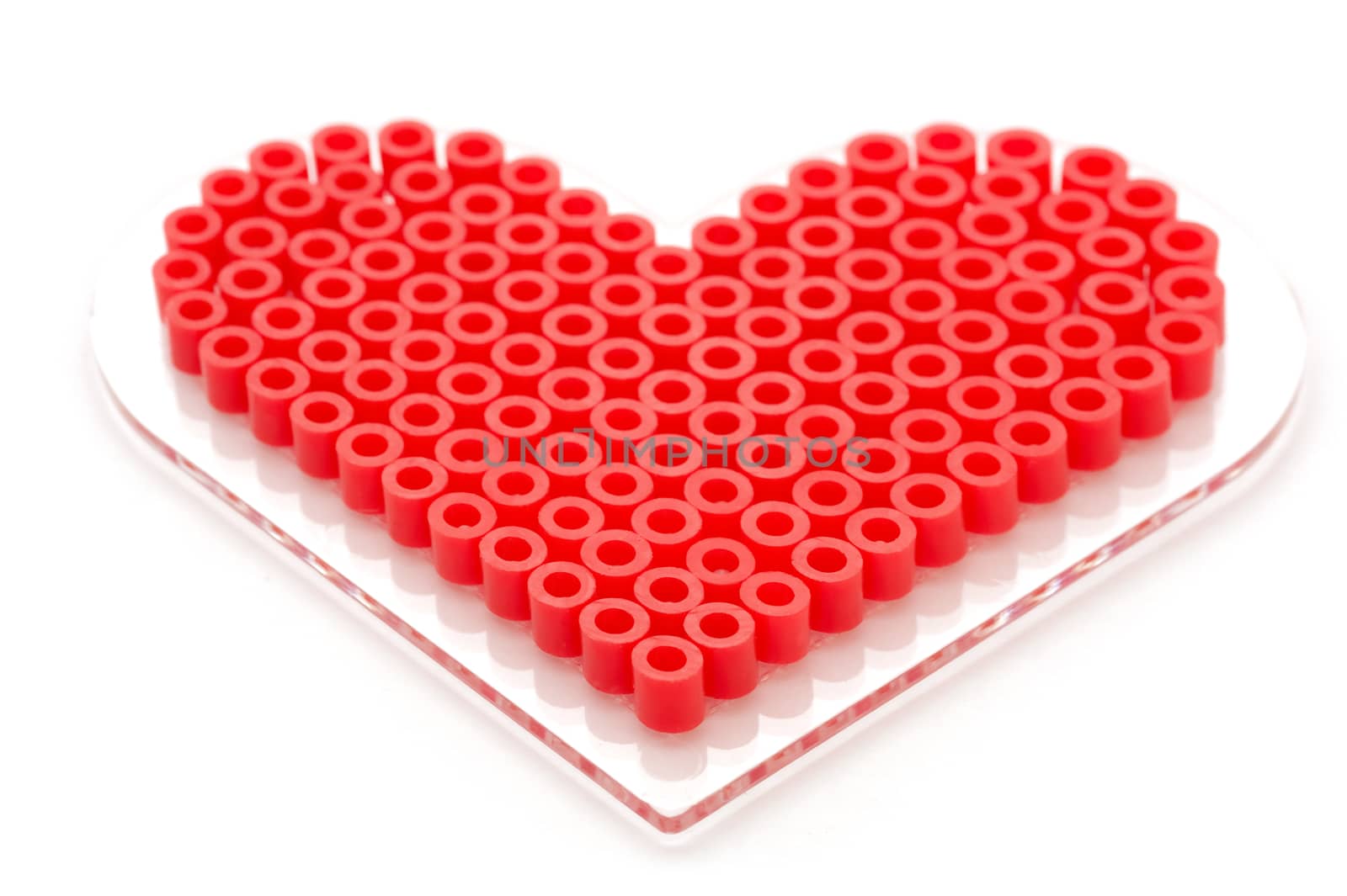 love heart made of decorative plastic beads on a white background