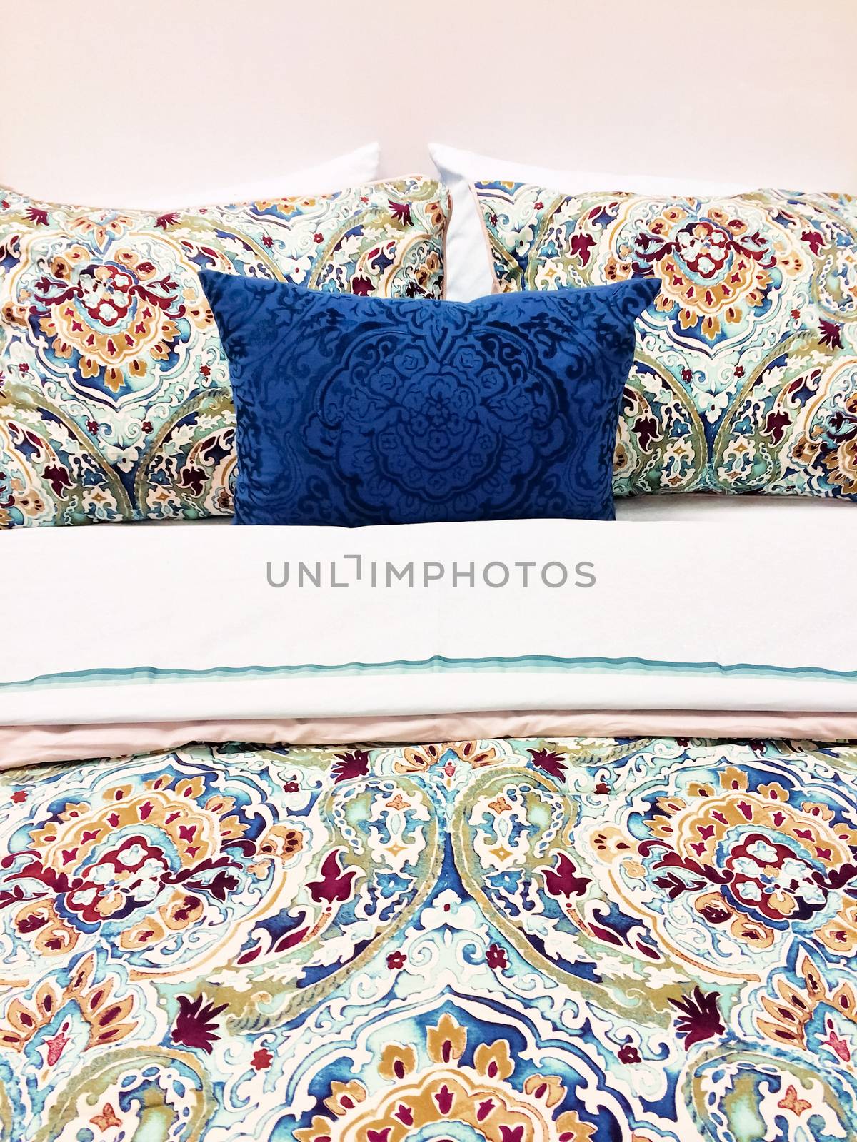 Close-up of a bed. Colorful bed linen with floral design.